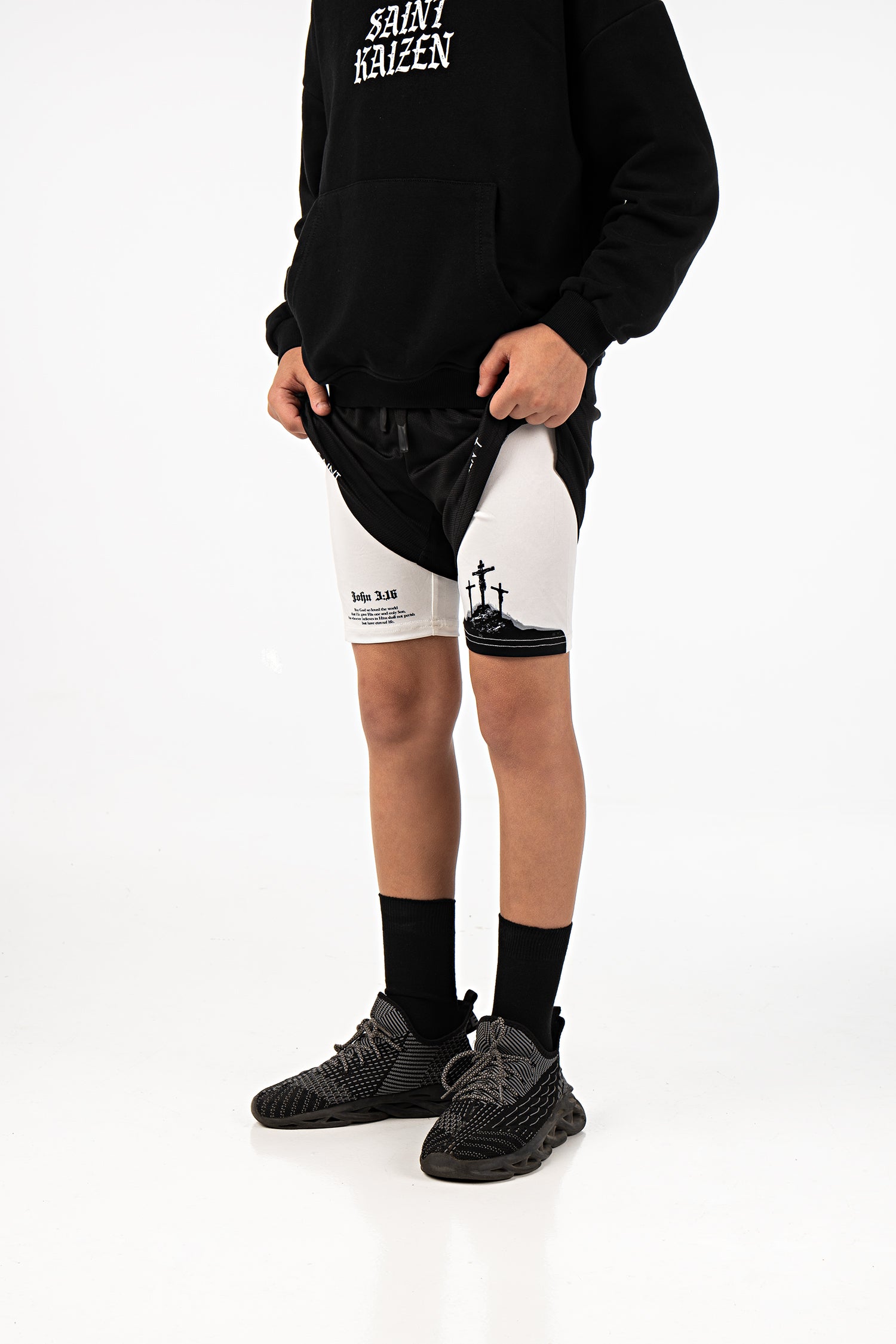 Saint Kaizen Christian gym wear Crucifixion Youth Performance Shorts. Two-layer shorts built for optimal mobility, featuring secure pockets and premium fabric.