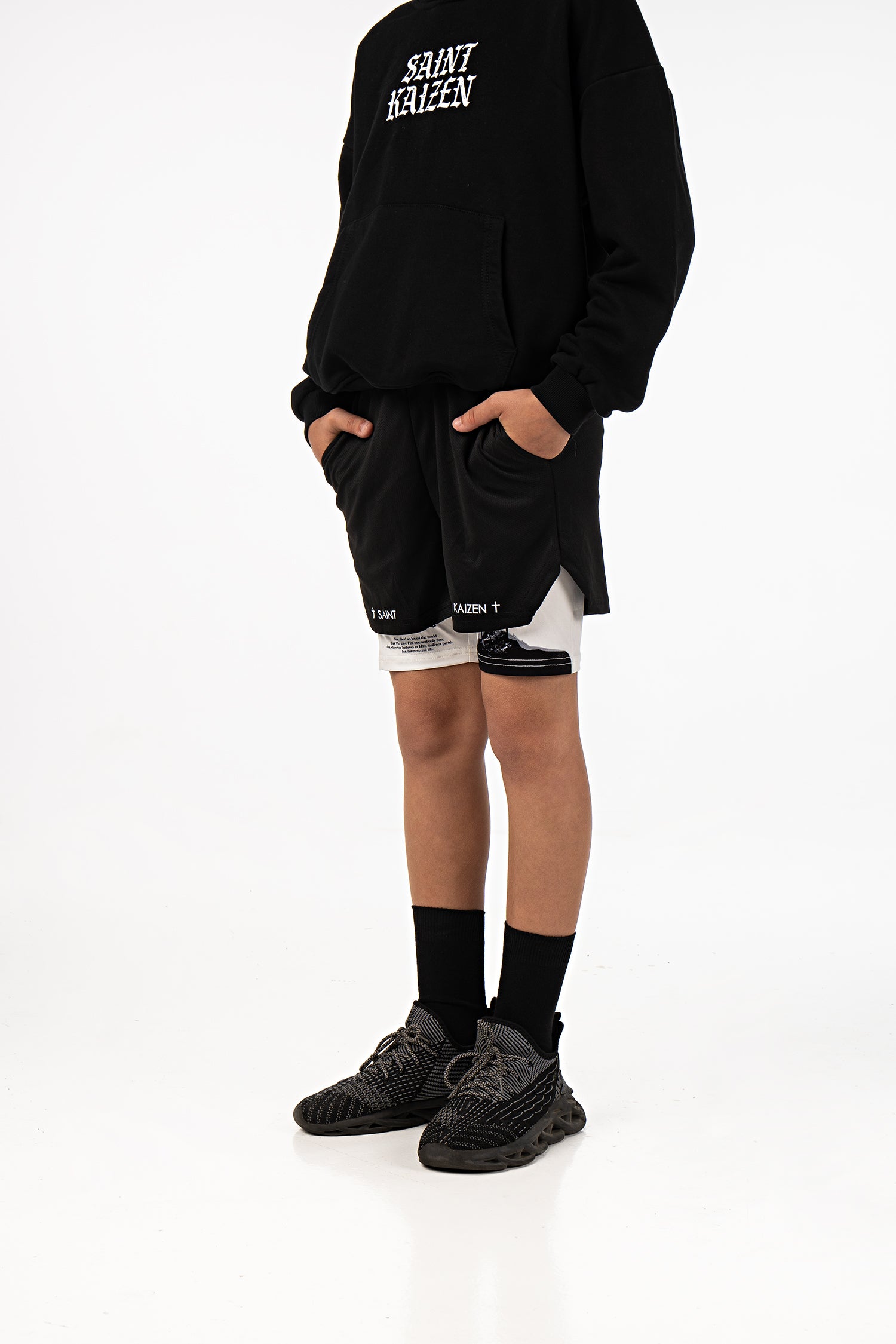 Saint Kaizen Christian gym wear Crucifixion Youth Performance Shorts. Two-layer shorts built for optimal mobility, featuring secure pockets and premium fabric.