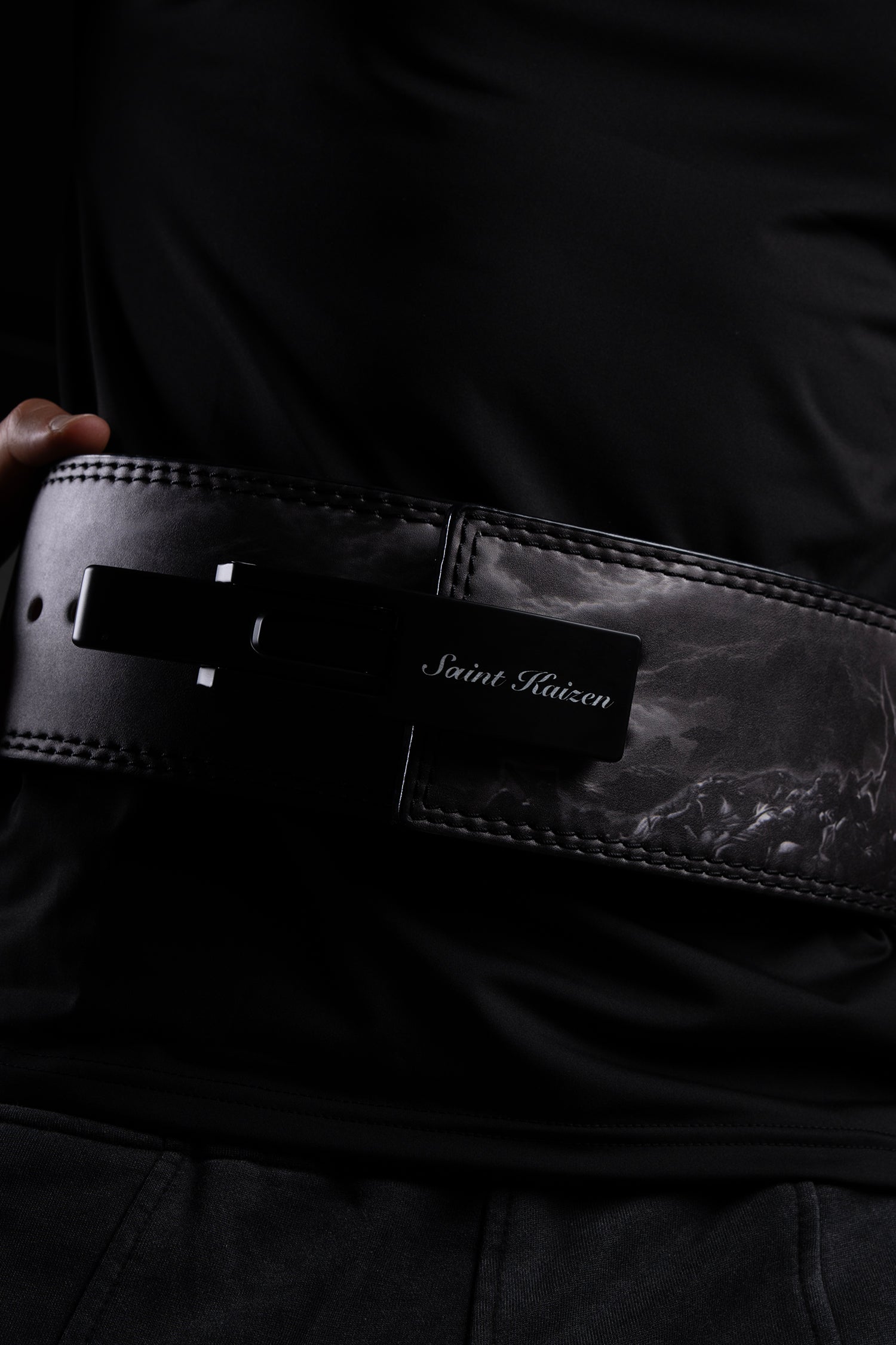 Close-up of the steel lever buckle on the Saint Kaizen Fear Not Lever Belt. This 10mm Weightlifting belt is essential for Powerlifting and is favored by Christian athletes.
