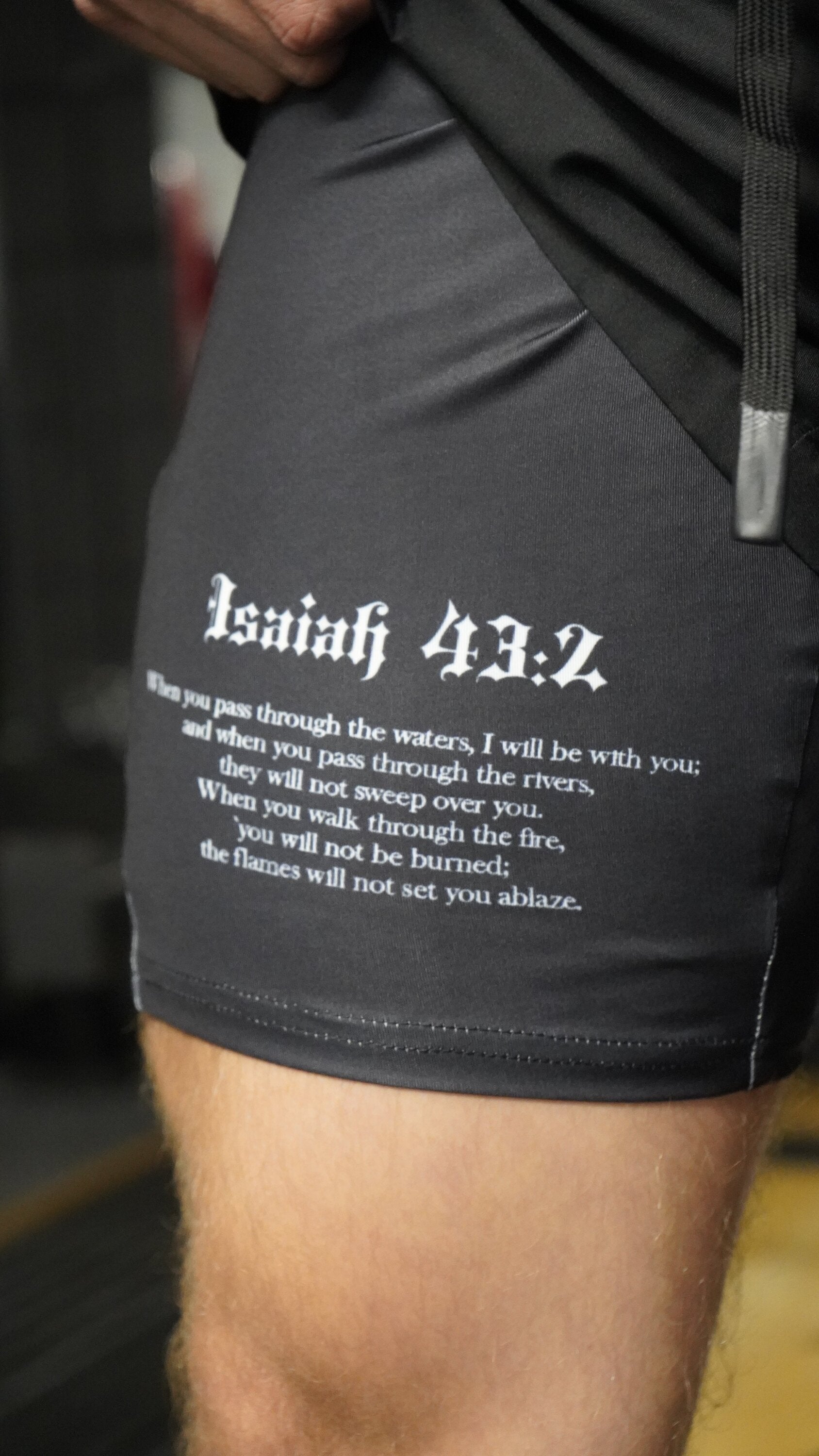 Saint Kaizen Christian gym wear God Is With Me - Performance Shorts. Two-layer shorts built for optimal mobility, featuring secure pockets and premium fabric.