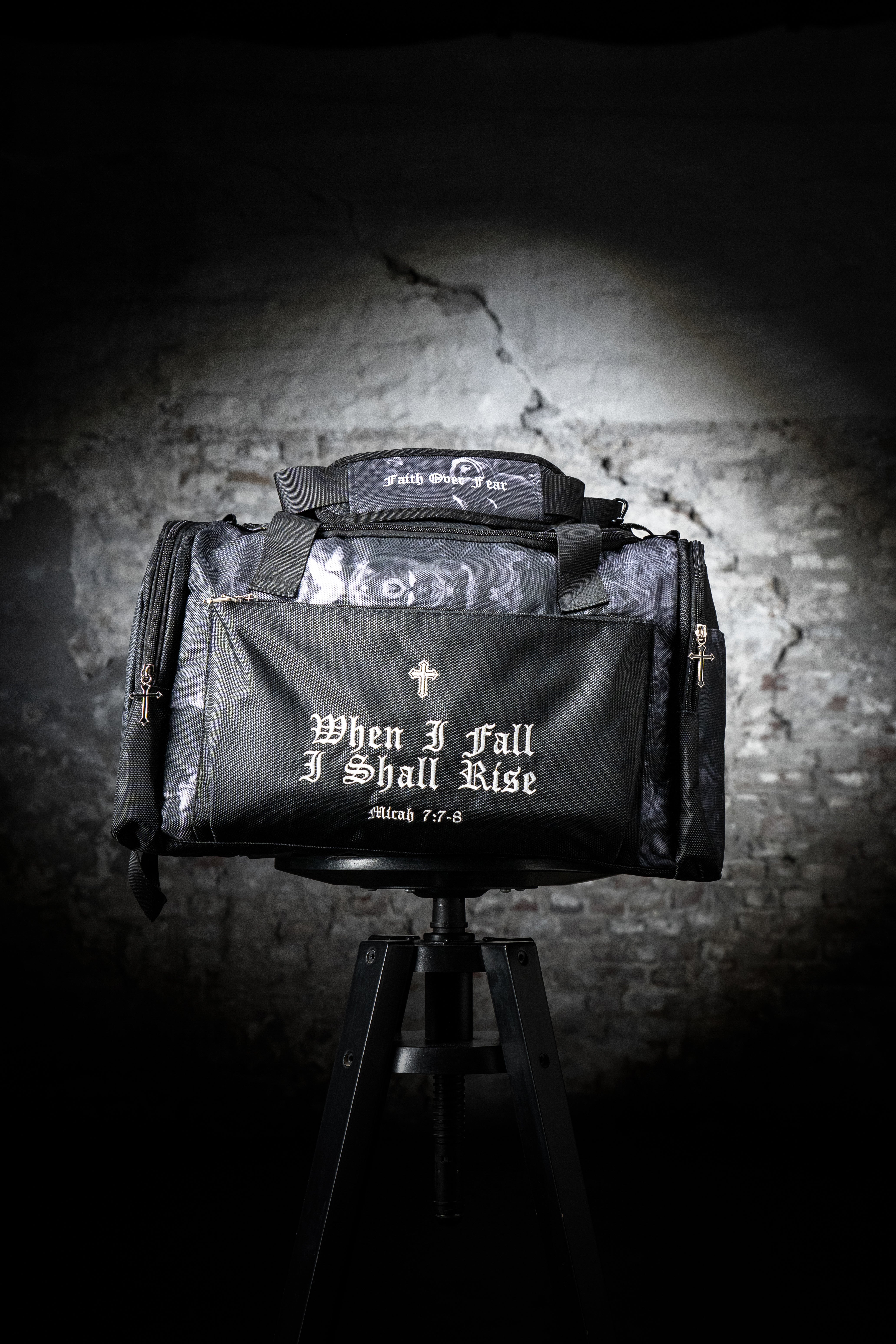 Saint Kaizen Christian gym duffle bag. Features the Light In The Darkness Duffle Bag verse, powerful spiritual artwork, and detailed embroidery for Christian athletes.