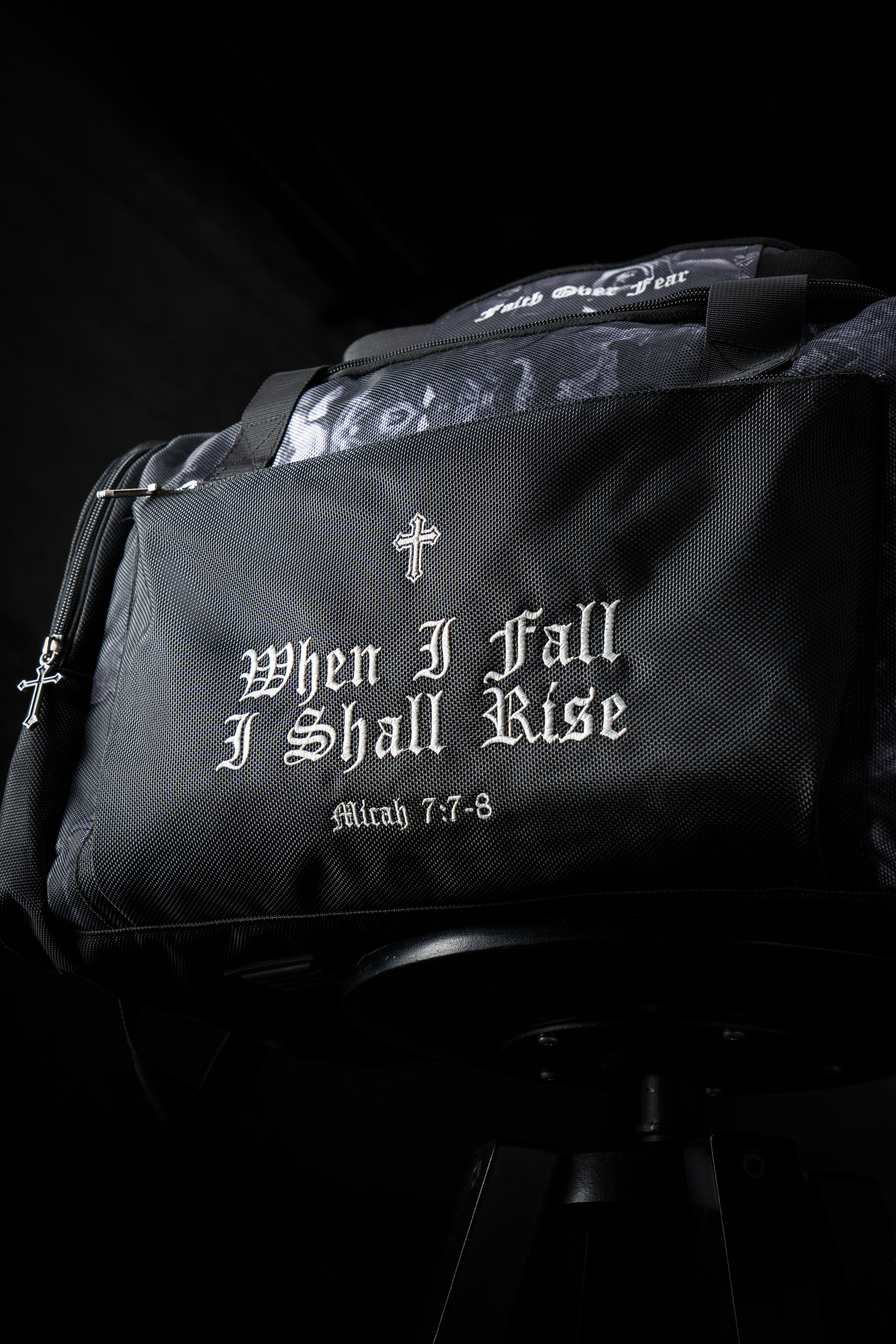 Saint Kaizen Christian gym duffle bag. Features the Light In The Darkness Duffle Bag verse, powerful spiritual artwork, and detailed embroidery for Christian athletes.