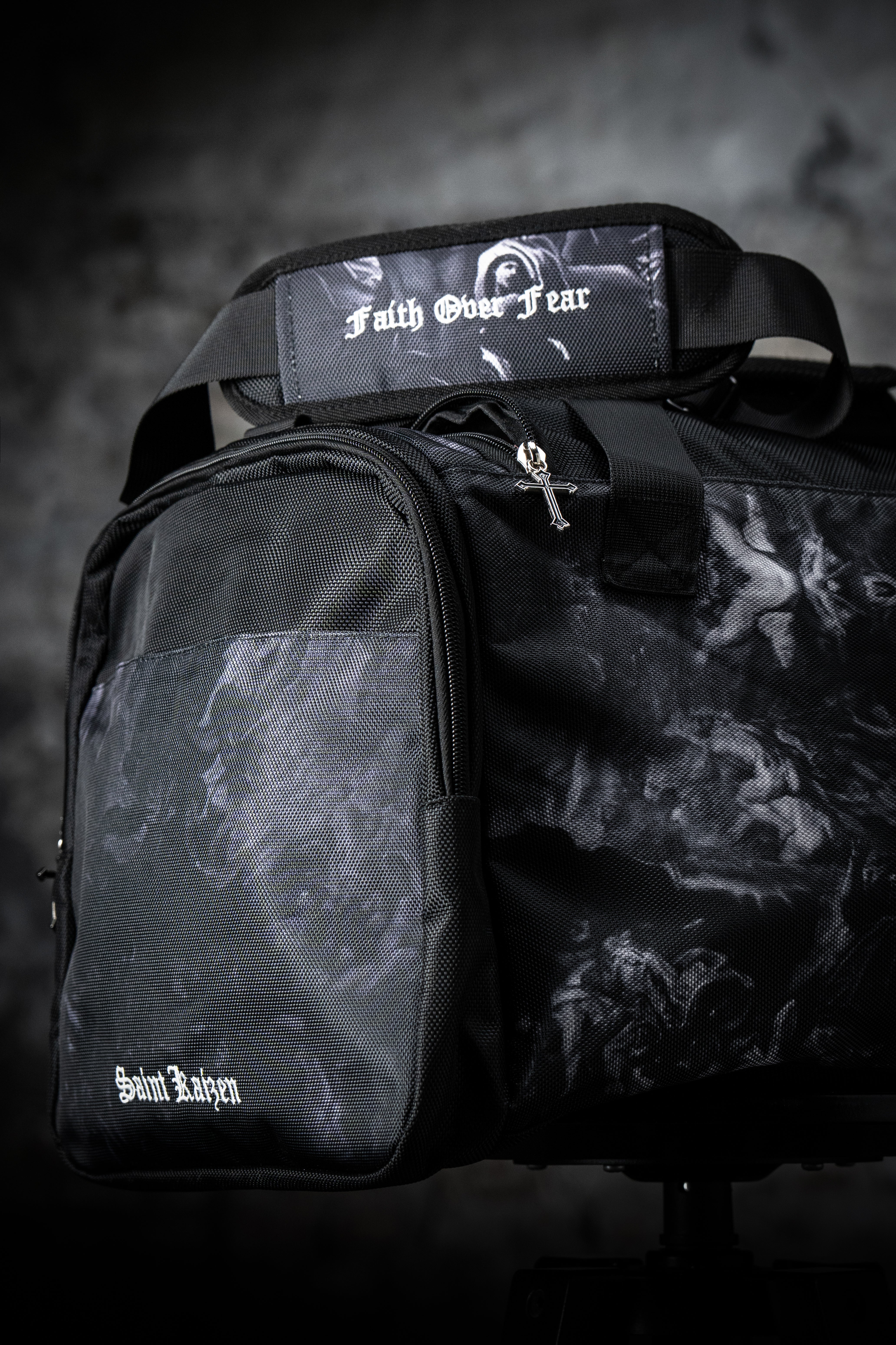 Saint Kaizen Christian gym duffle bag. Features the Light In The Darkness Duffle Bag verse, powerful spiritual artwork, and detailed embroidery for Christian athletes.
