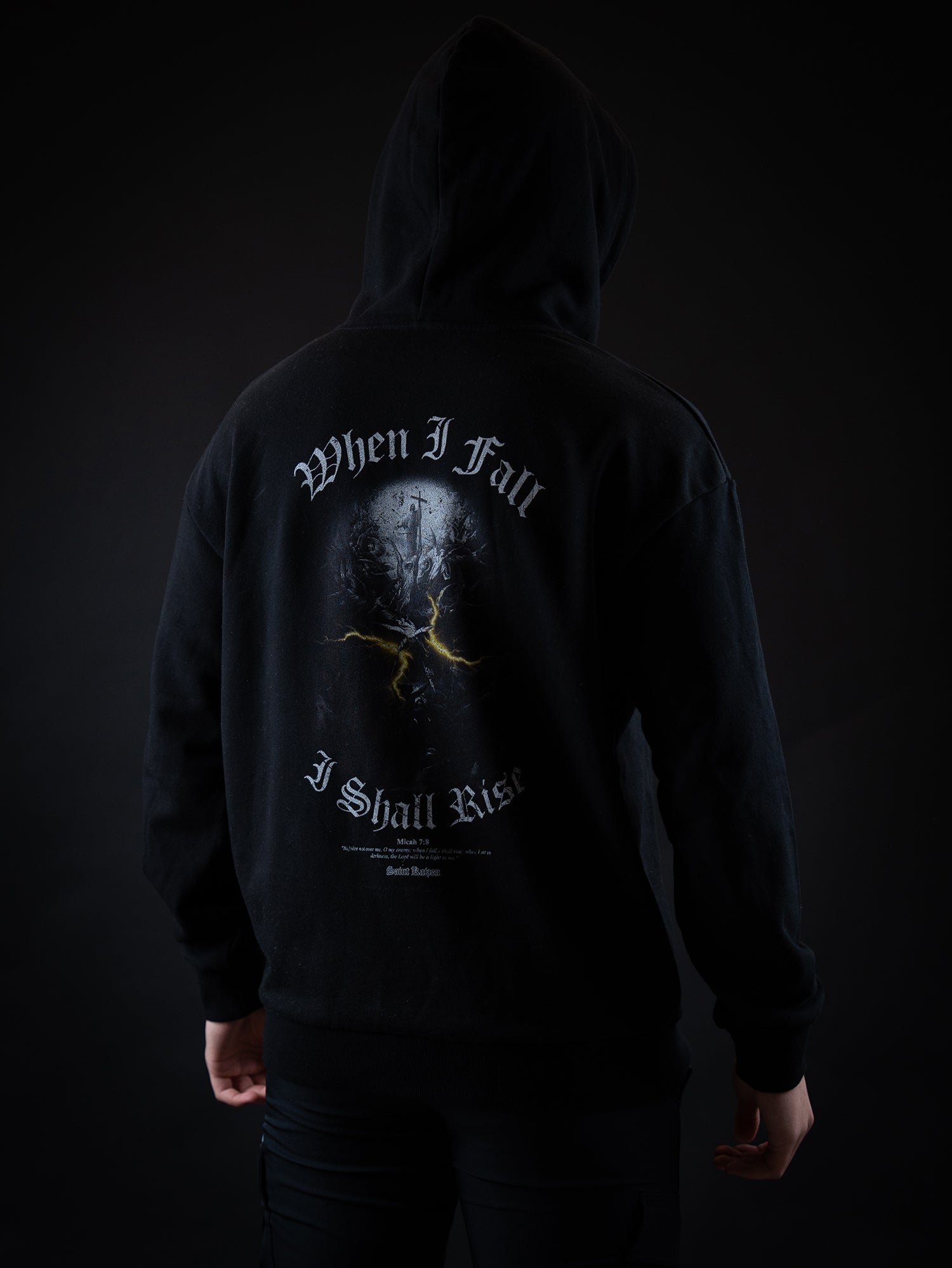 Saint Kaizen Light In The Darkness Hoodie - Black. Heavyweight Christian gym wear hoodie featuring a durable with spiritual artwork.