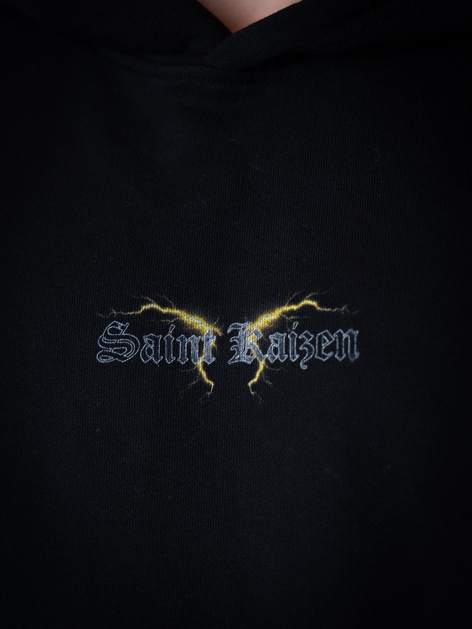 Saint Kaizen Light In The Darkness Hoodie - Black. Heavyweight Christian gym wear hoodie featuring a durable with spiritual artwork.