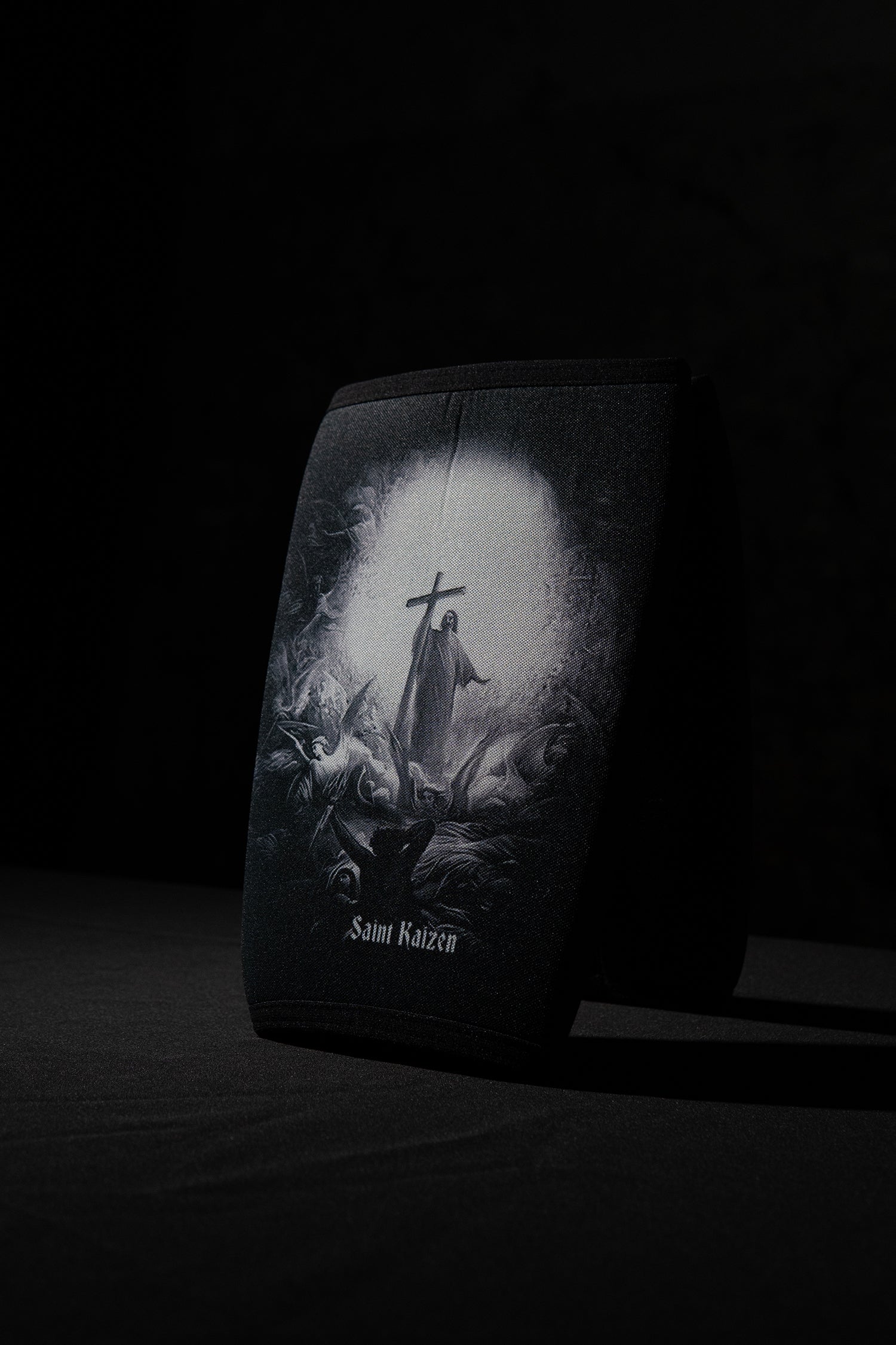 Saint Kaizen Light In The Darkness Knee Sleeves. 7mm neoprene for maximum compression and support during squats and deadlifts. Essential Christian gym wear.