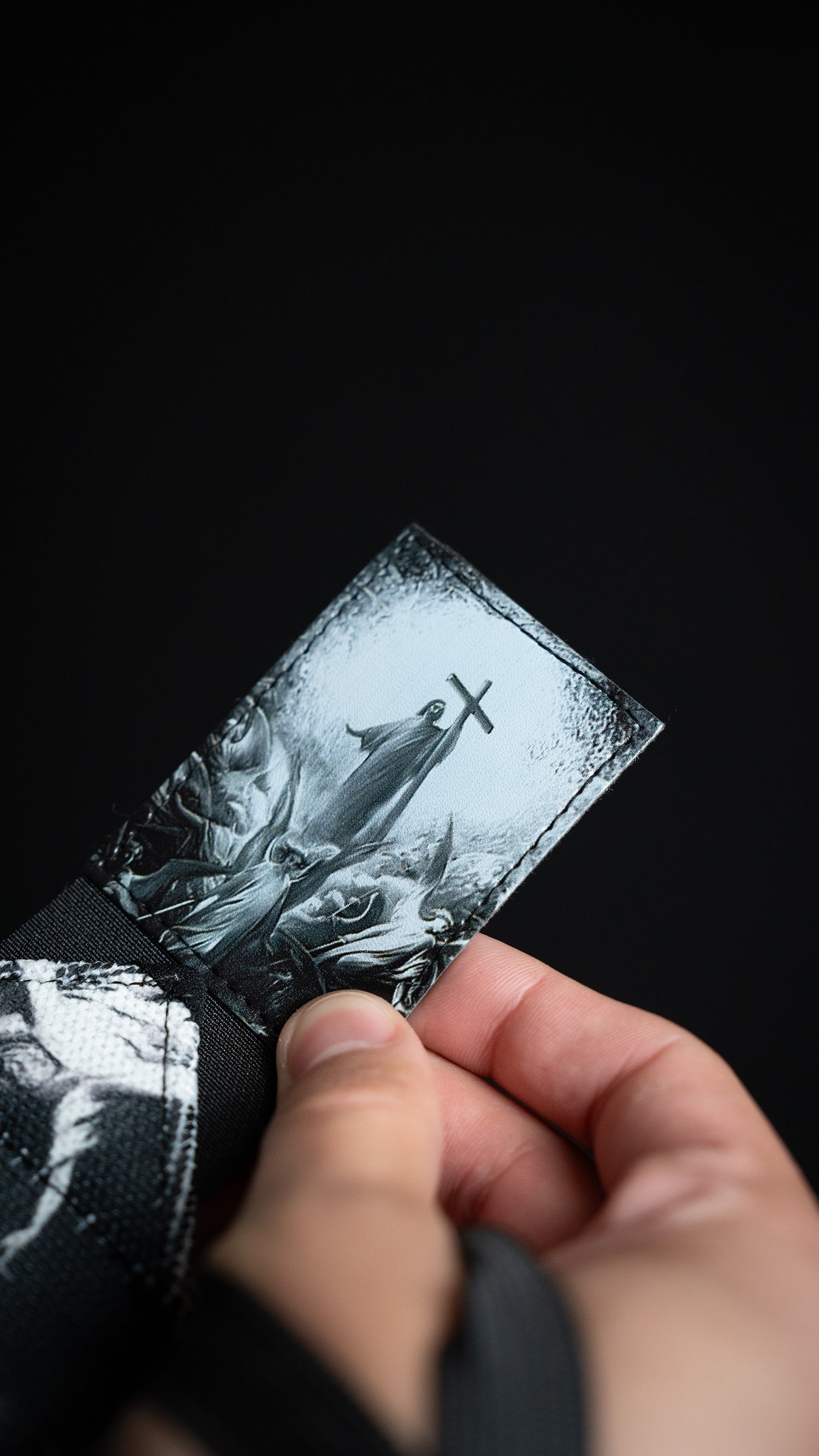 Saint Kaizen Light In The Darkness Wrist Wraps. Christian gym wear accessory featuring bold spiritual print and heavy-duty Velcro for stability.