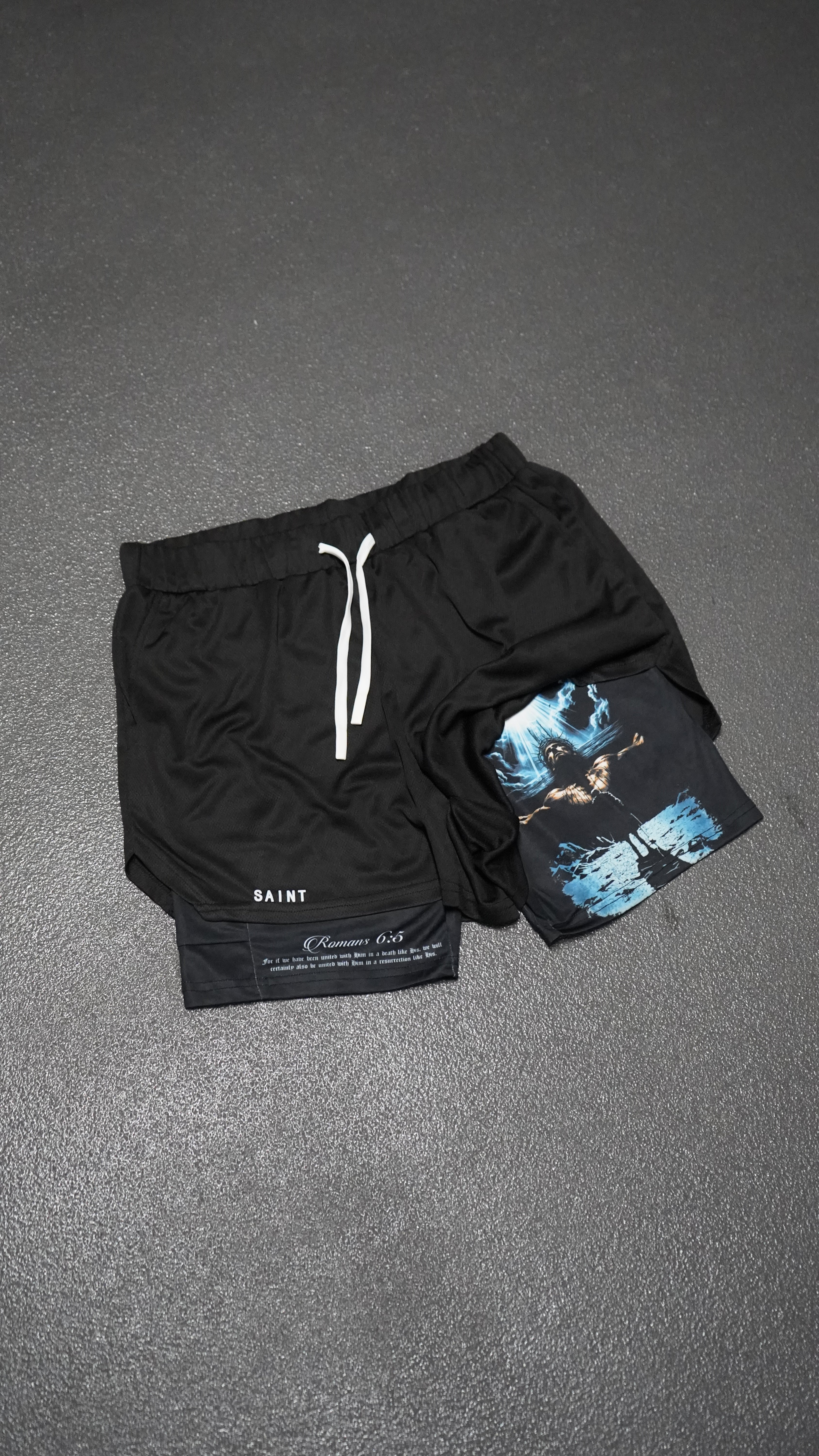 Saint Kaizen Christian gym wear Romans 5:6 Performance Shorts. Two-layer shorts built for optimal mobility, featuring secure pockets and premium fabric.