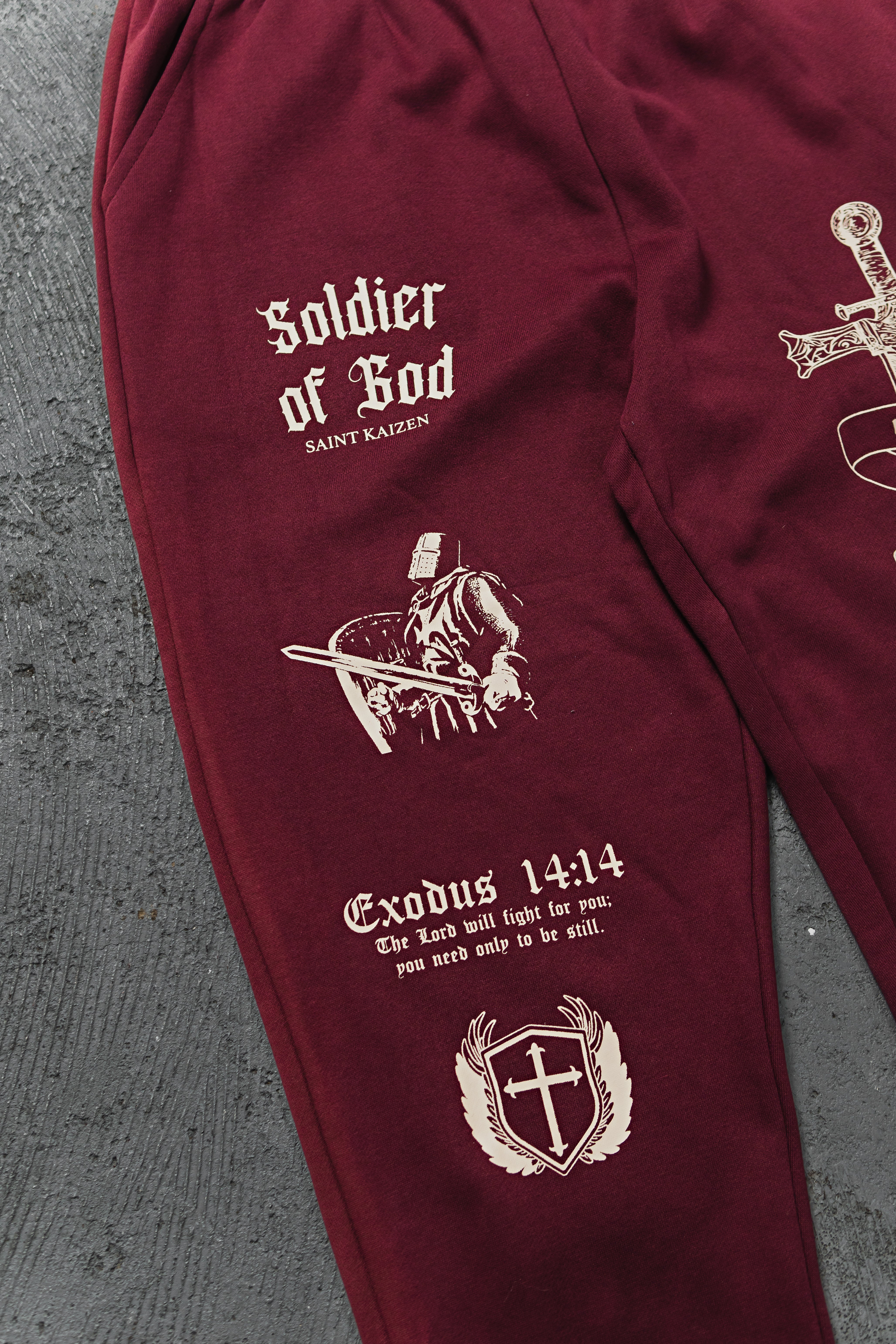 Saint Kaizen Soldier Of God Joggers - Wine. Christian gym wear with high-quality screen print design. Terry fleece lining for warmth and comfort.