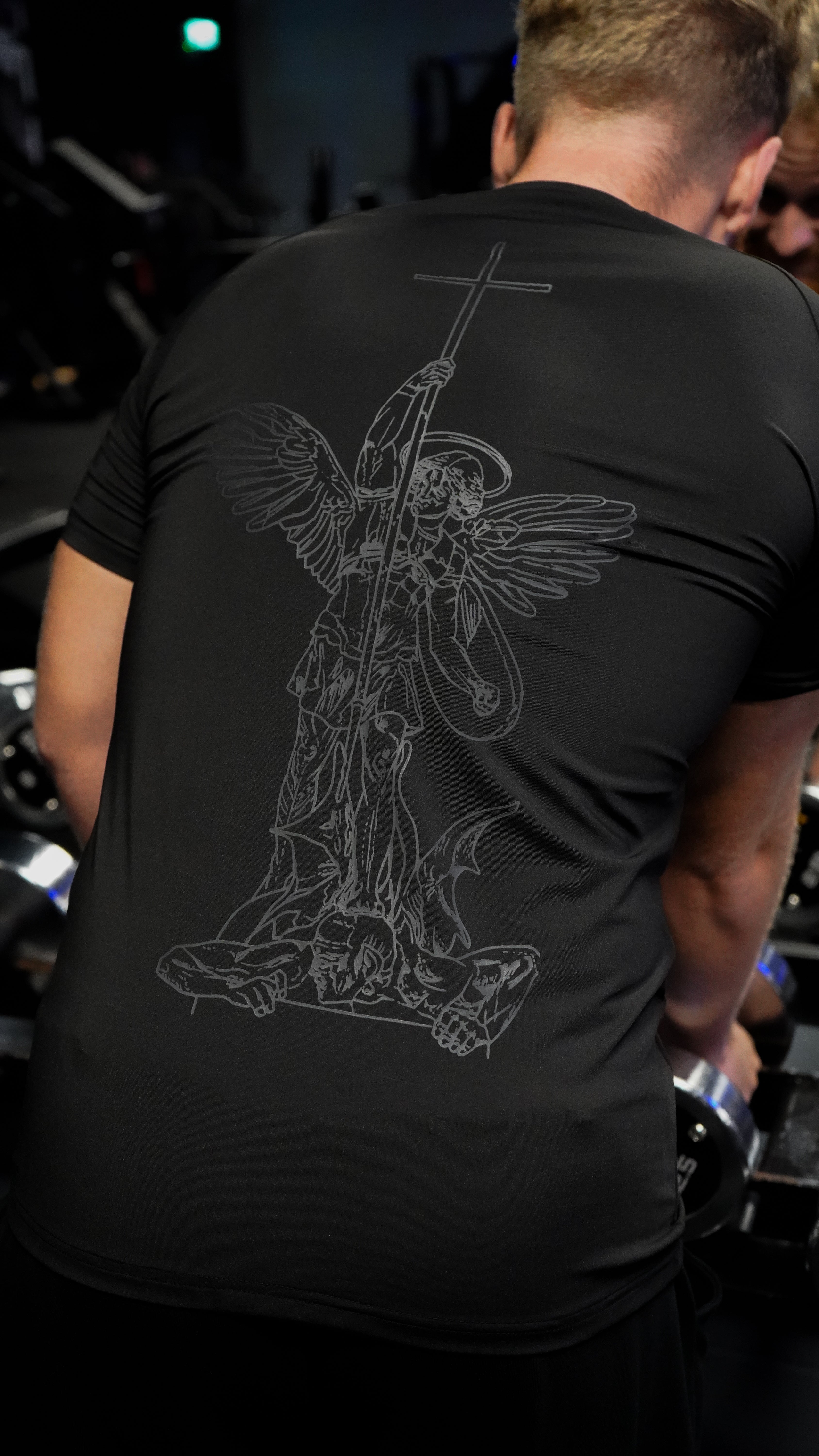 Saint Kaizen Angel Warrior Compression Tee. High-performance Christian gym wear with printed spiritual artwork. Tailored, ergonomic fit for muscle support.