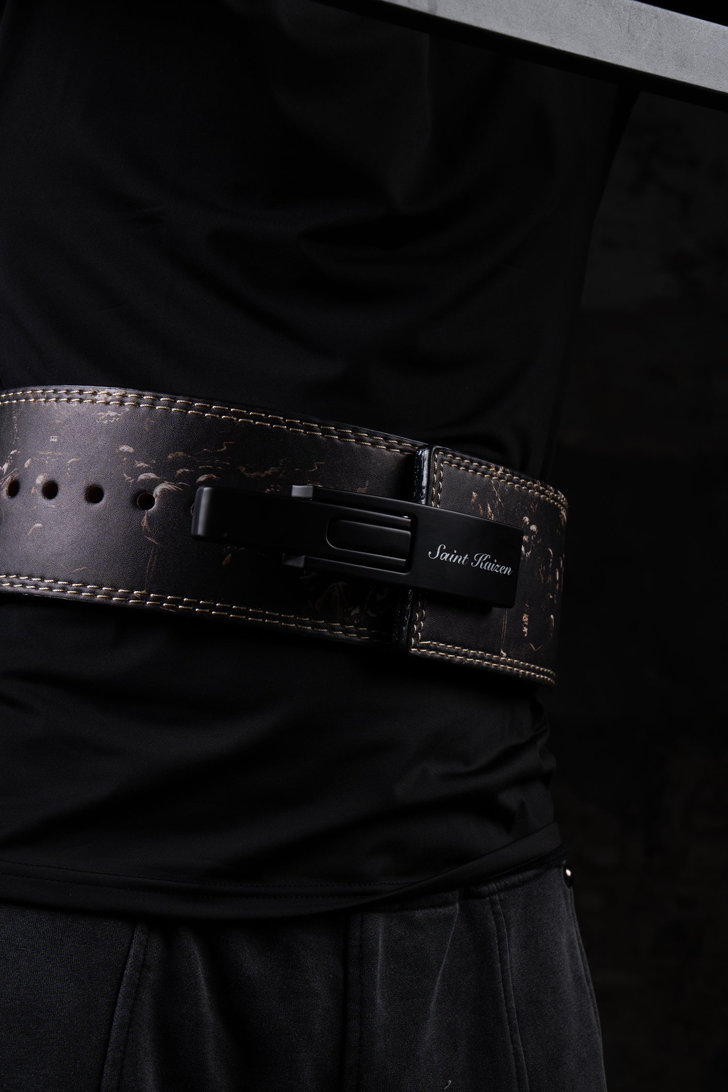 Close-up of the steel lever buckle on the Saint Kaizen Cross Camo Lever Belt. This 10mm Weightlifting belt is essential for Powerlifting and is favored by Christian athletes.