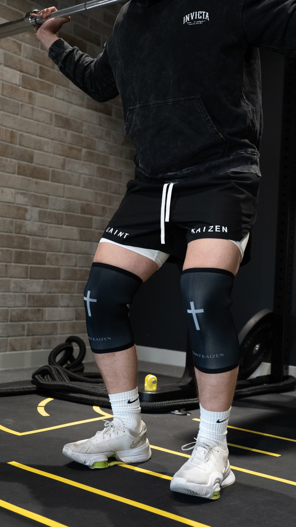 Saint Kaizen Cross Knee Sleeves. 7mm neoprene for maximum compression and support during squats and deadlifts. Essential Christian gym wear.