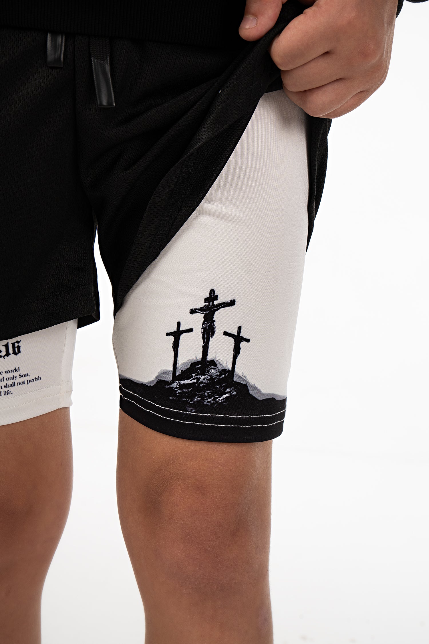 Saint Kaizen Christian gym wear Crucifixion Youth Performance Shorts. Two-layer shorts built for optimal mobility, featuring secure pockets and premium fabric.
