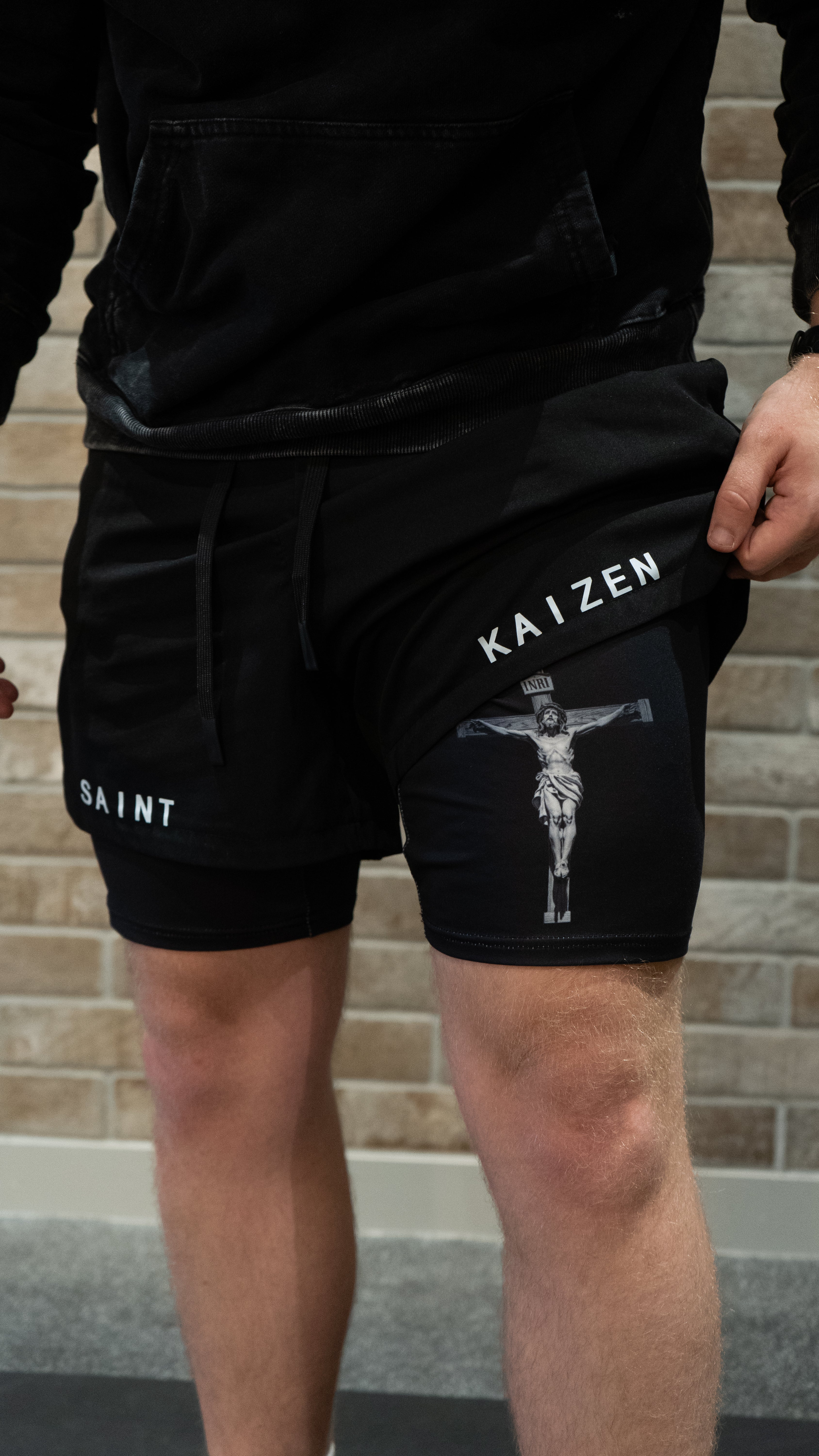 Christian-themed performance shorts with Bible verses, made from a blend of cotton and polyester with a spandex inner lining, featuring Saint Kaizen screen print and multiple pockets for convenience.