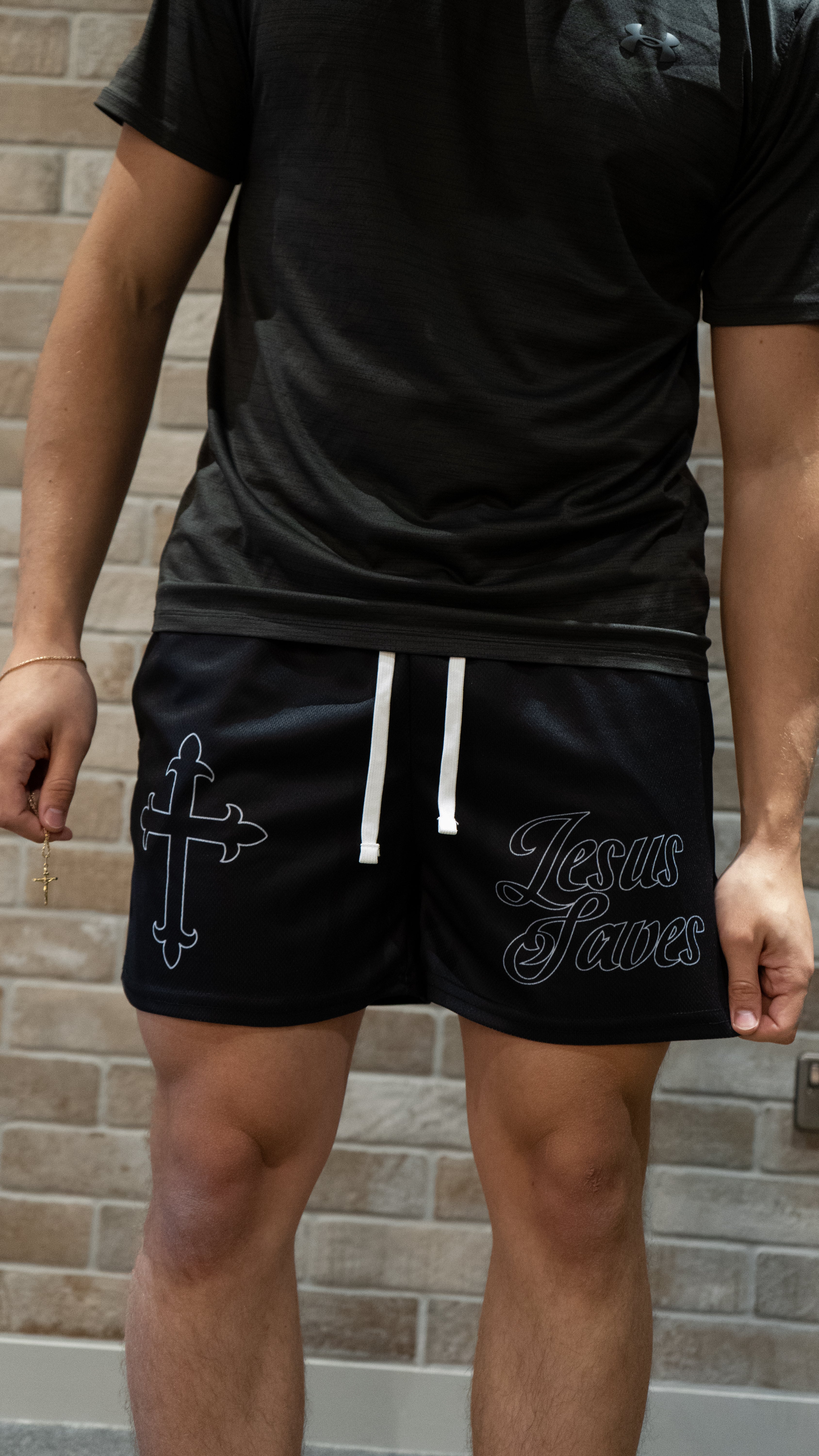 Christian-themed mesh gym shorts with Bible verses, made from 100% polyester, featuring double side pockets and a 5-inch inseam for comfort and mobility.