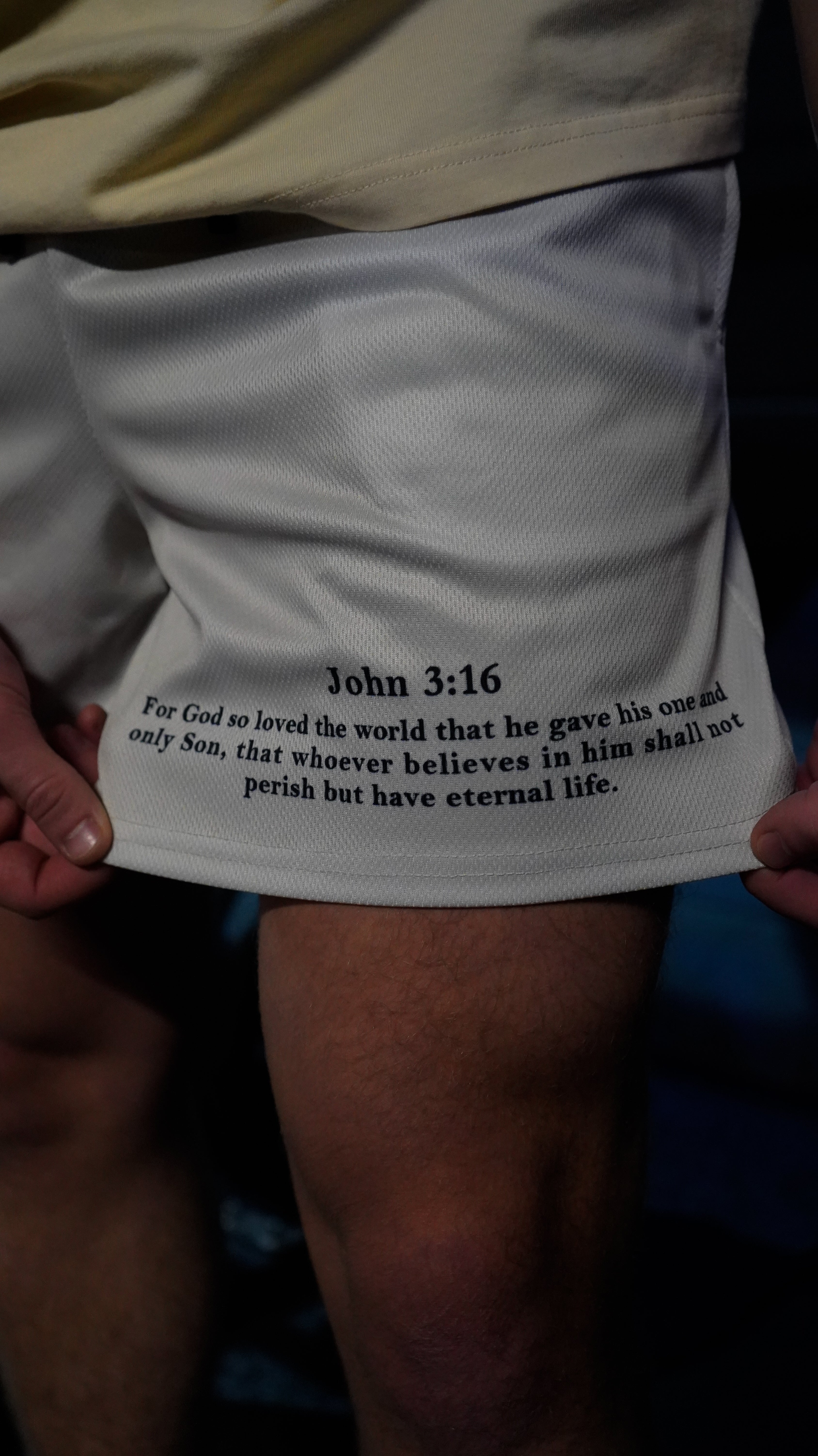 Christian-themed mesh gym shorts with Bible verses, made from 100% polyester, featuring double side pockets and a 5-inch inseam for comfort and mobility.