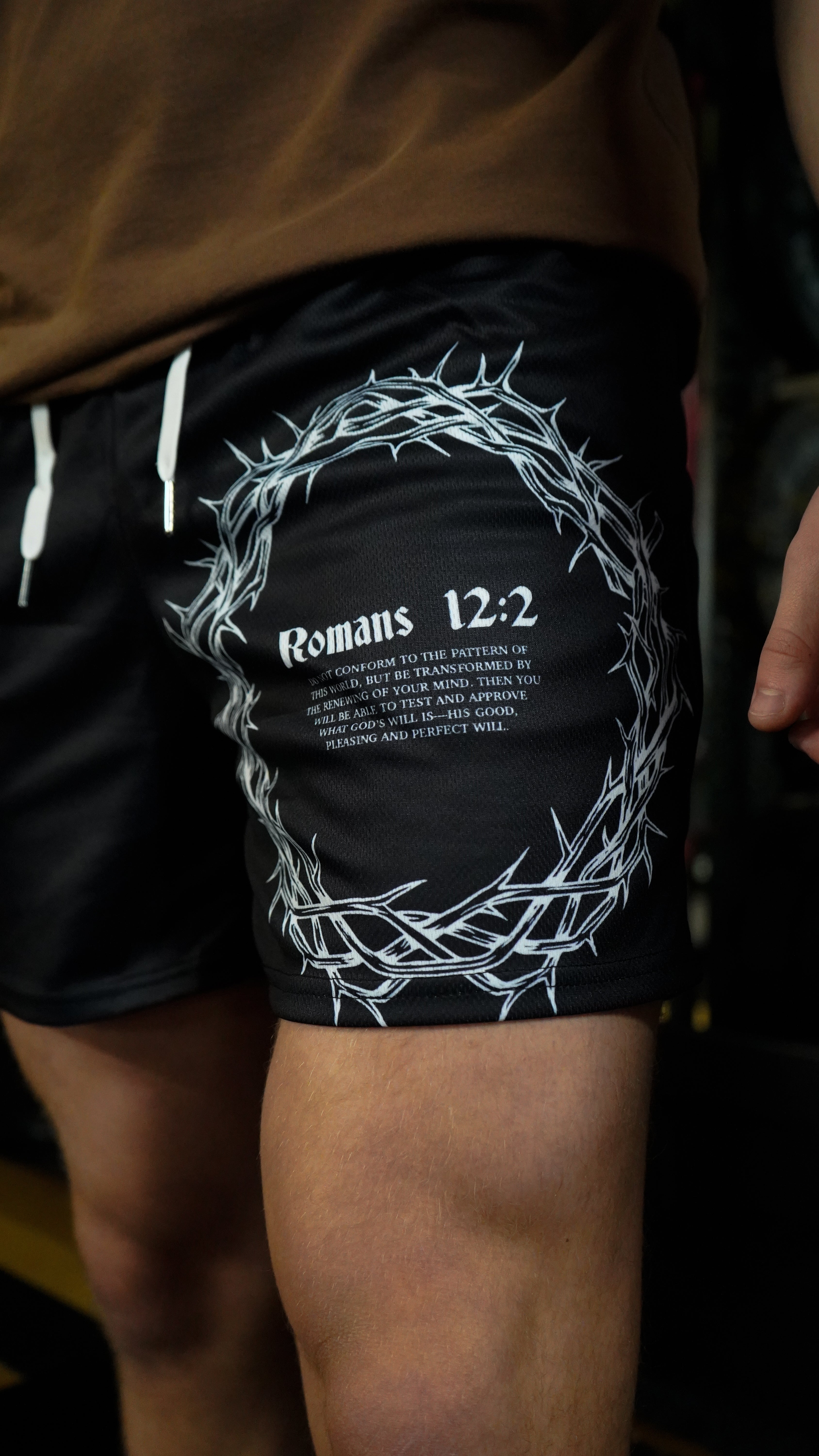 Christian-themed mesh gym shorts with Bible verses, made from 100% polyester, featuring double side pockets and a 5-inch inseam for comfort and mobility.