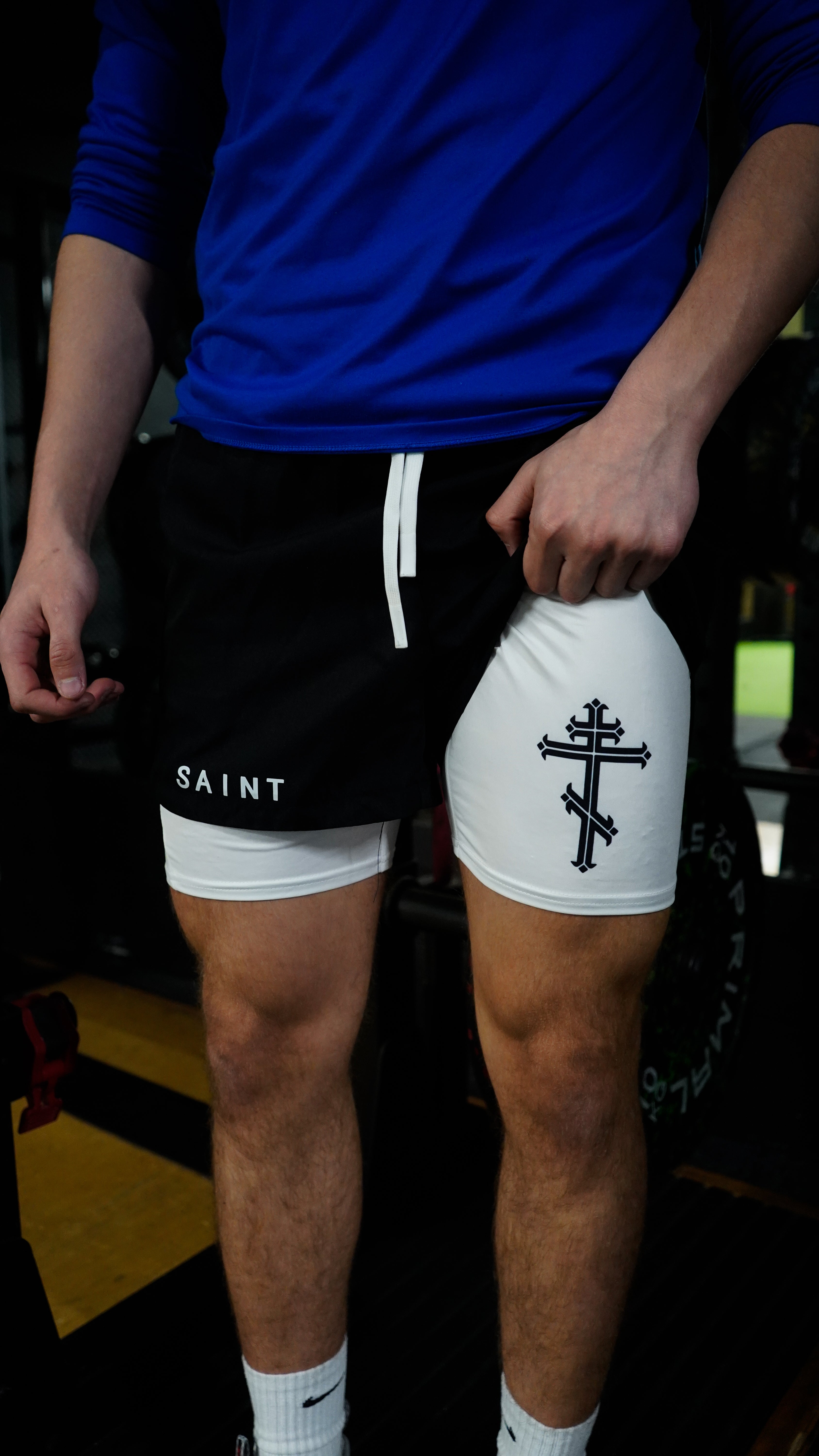 Christian-themed performance shorts with Bible verses, made from a blend of cotton and polyester with a spandex inner lining, featuring Saint Kaizen screen print and multiple pockets for convenience.