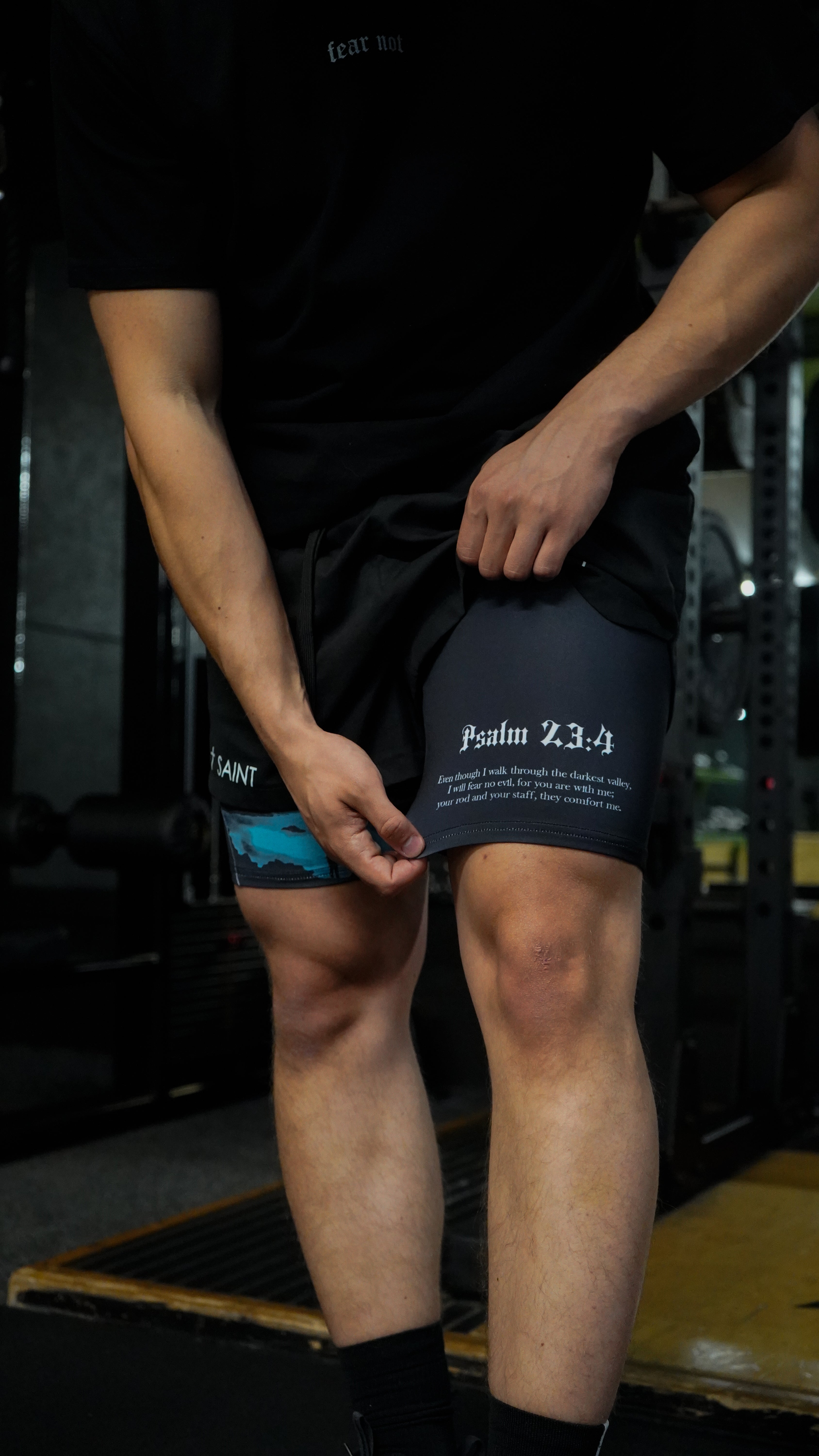 Christian-themed performance shorts with Bible verses, made from a blend of cotton and polyester with a spandex inner lining, featuring Saint Kaizen screen print and multiple pockets for convenience.