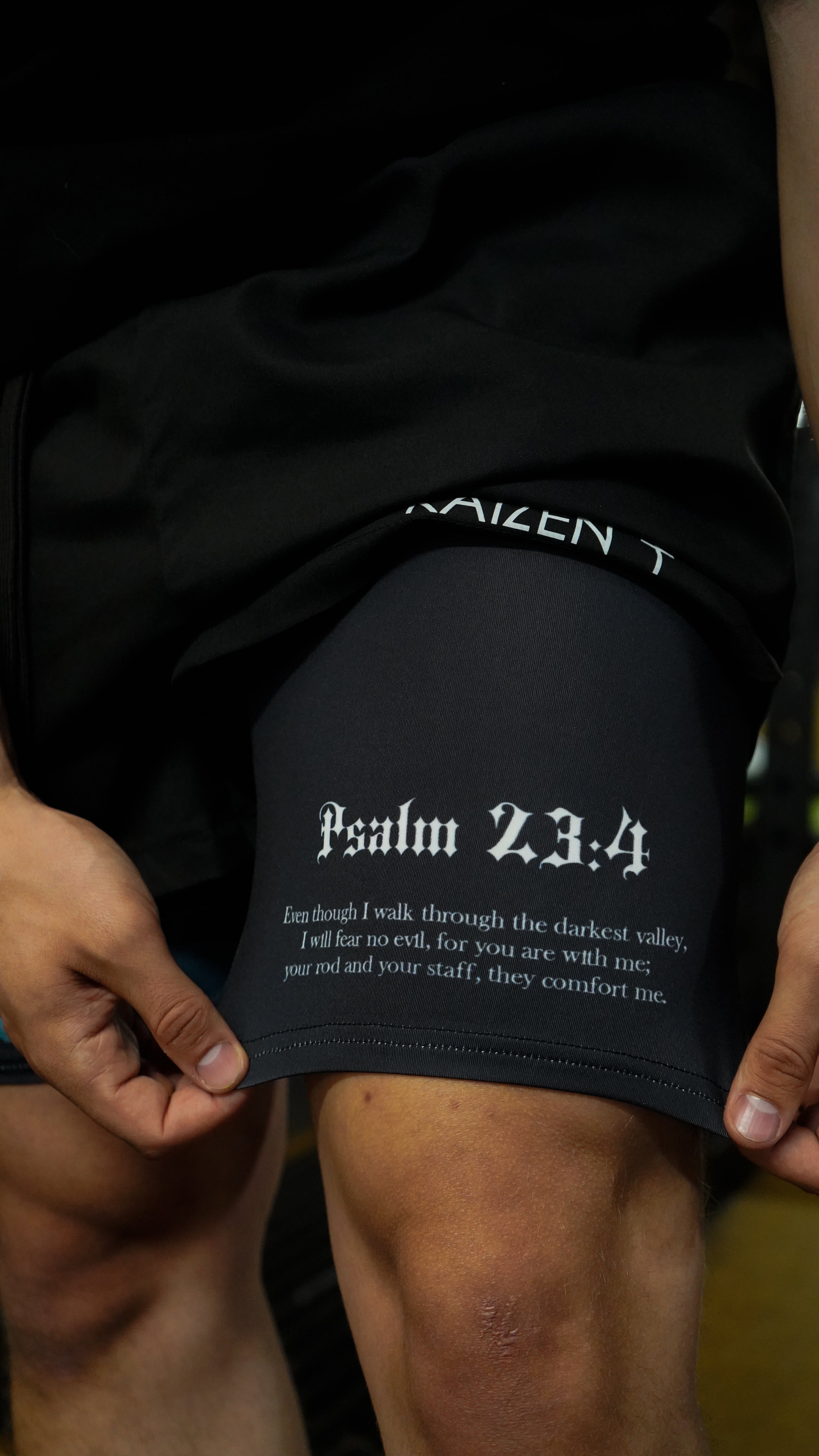 Christian-themed performance shorts with Bible verses, made from a blend of cotton and polyester with a spandex inner lining, featuring Saint Kaizen screen print and multiple pockets for convenience.