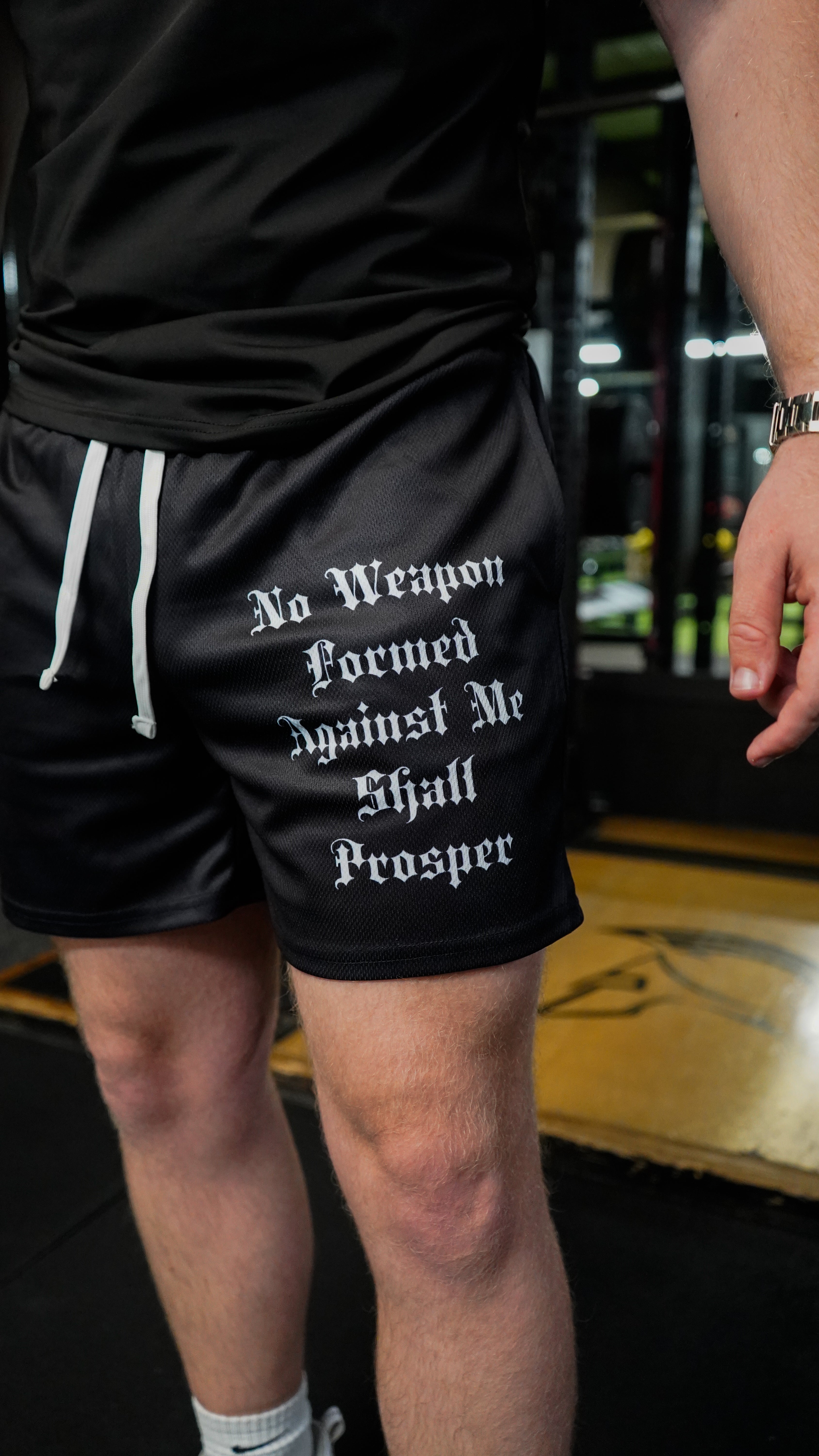 Christian-themed mesh gym shorts with Bible verses, made from 100% polyester, featuring double side pockets and a 5-inch inseam for comfort and mobility.