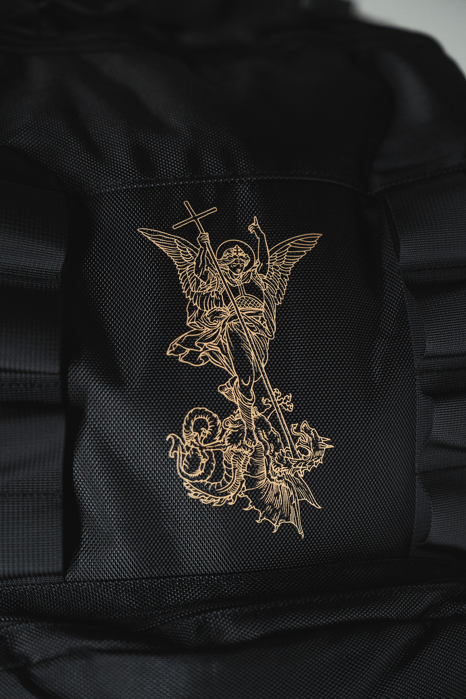 Saint Kaizen Fear Not Backpack for Christian athletes. Features Isaiah 41:10 text and gold silk-printed Archangel Michael artwork.