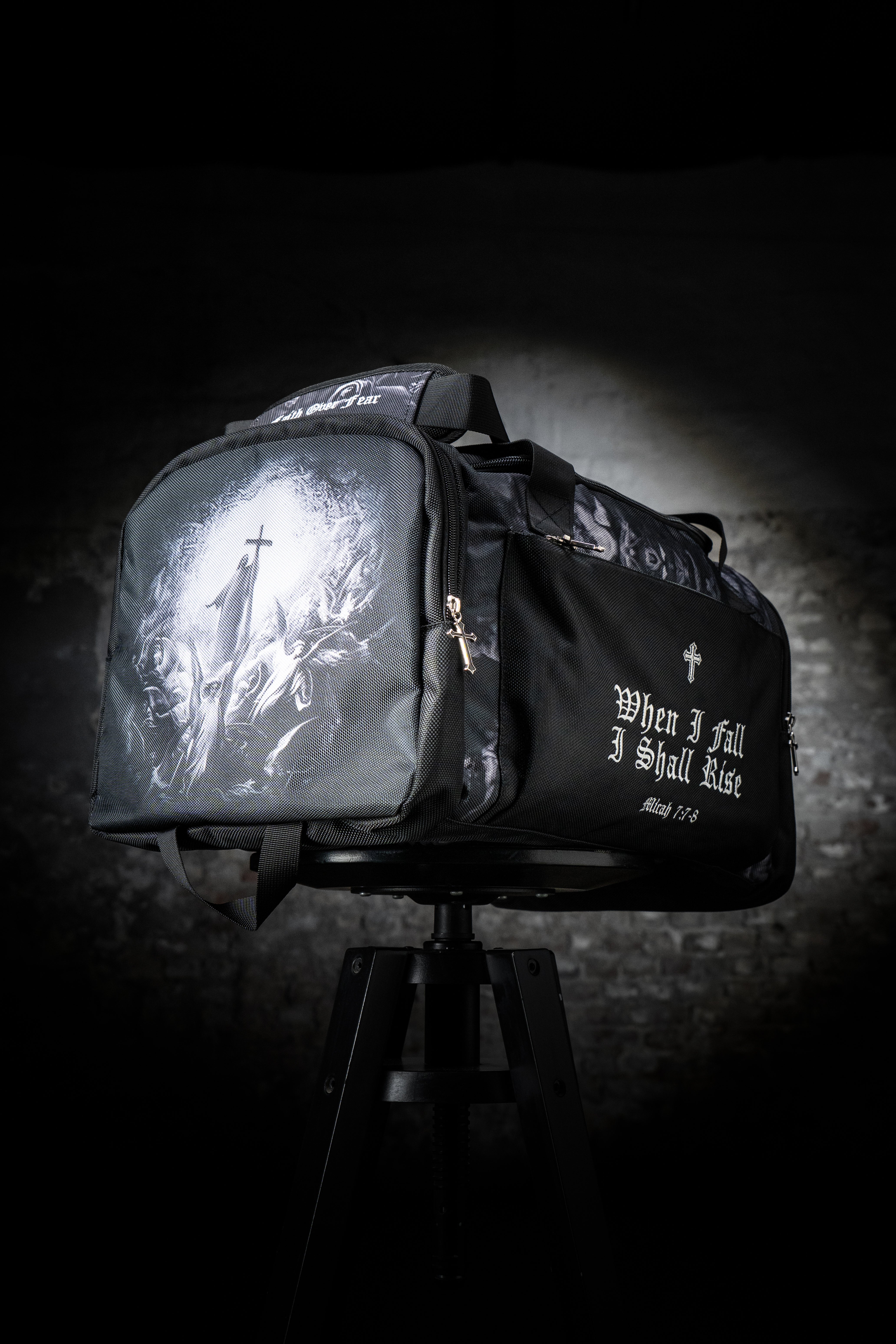 Saint Kaizen Christian gym duffle bag. Features the Light In The Darkness Duffle Bag verse, powerful spiritual artwork, and detailed embroidery for Christian athletes.
