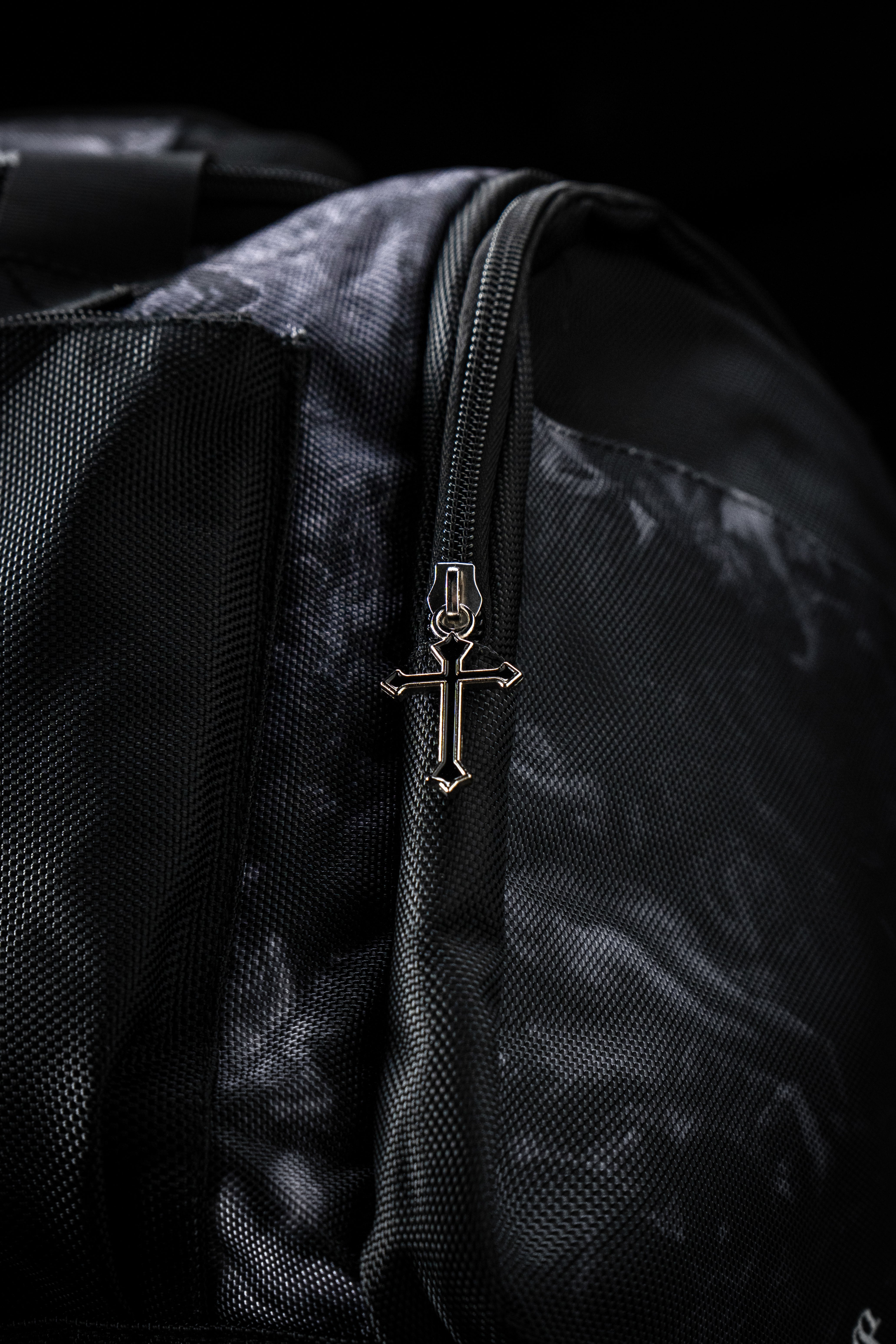 Detailed view of the custom cross zippers on the Saint Kaizen Light In The Darkness Duffle Bag. Premium quality duffle bag designed specifically for Christian athletes.
