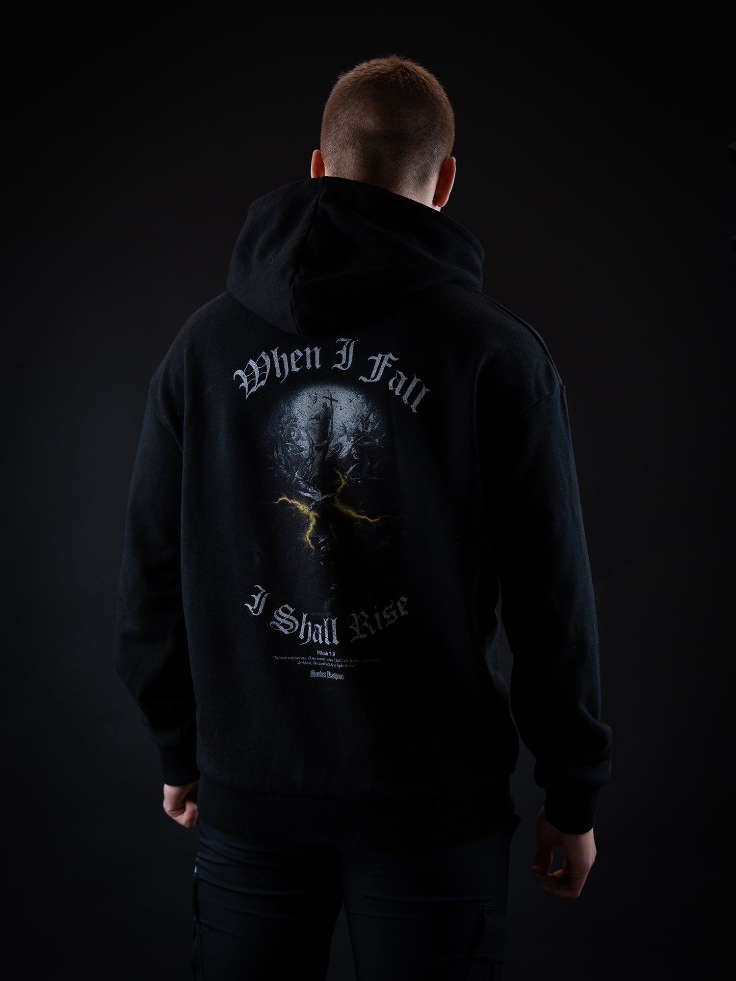 Saint Kaizen Light In The Darkness Hoodie - Black. Heavyweight Christian gym wear hoodie featuring a durable with spiritual artwork.