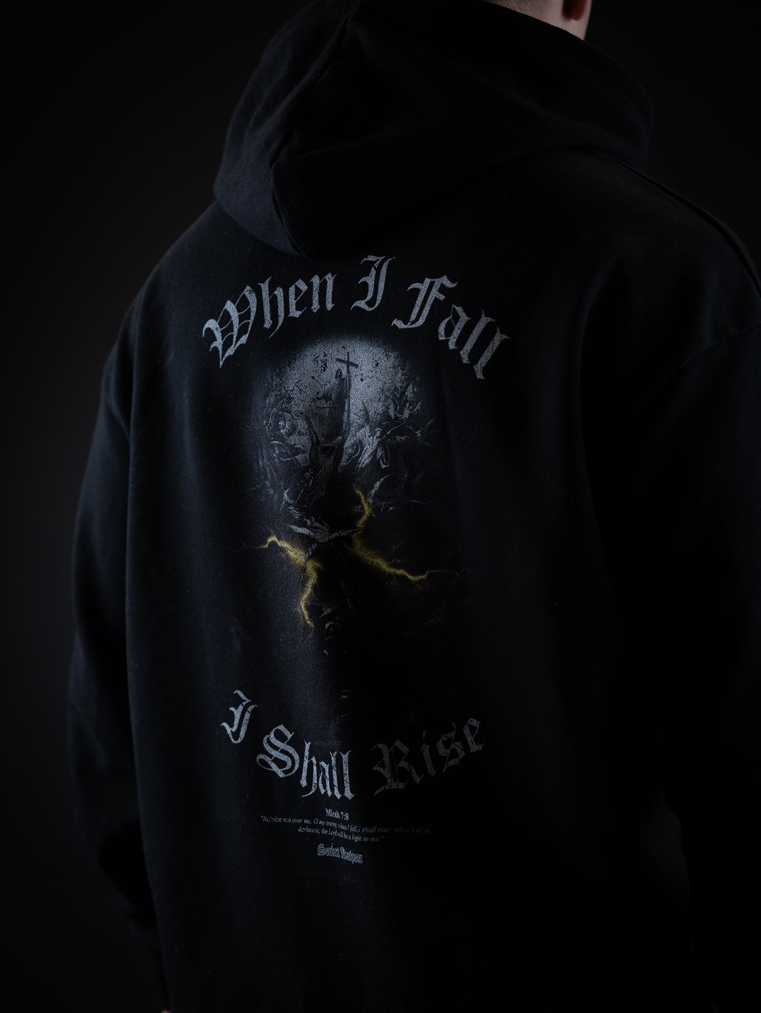 Saint Kaizen Light In The Darkness Hoodie - Black. Heavyweight Christian gym wear hoodie featuring a durable with spiritual artwork.