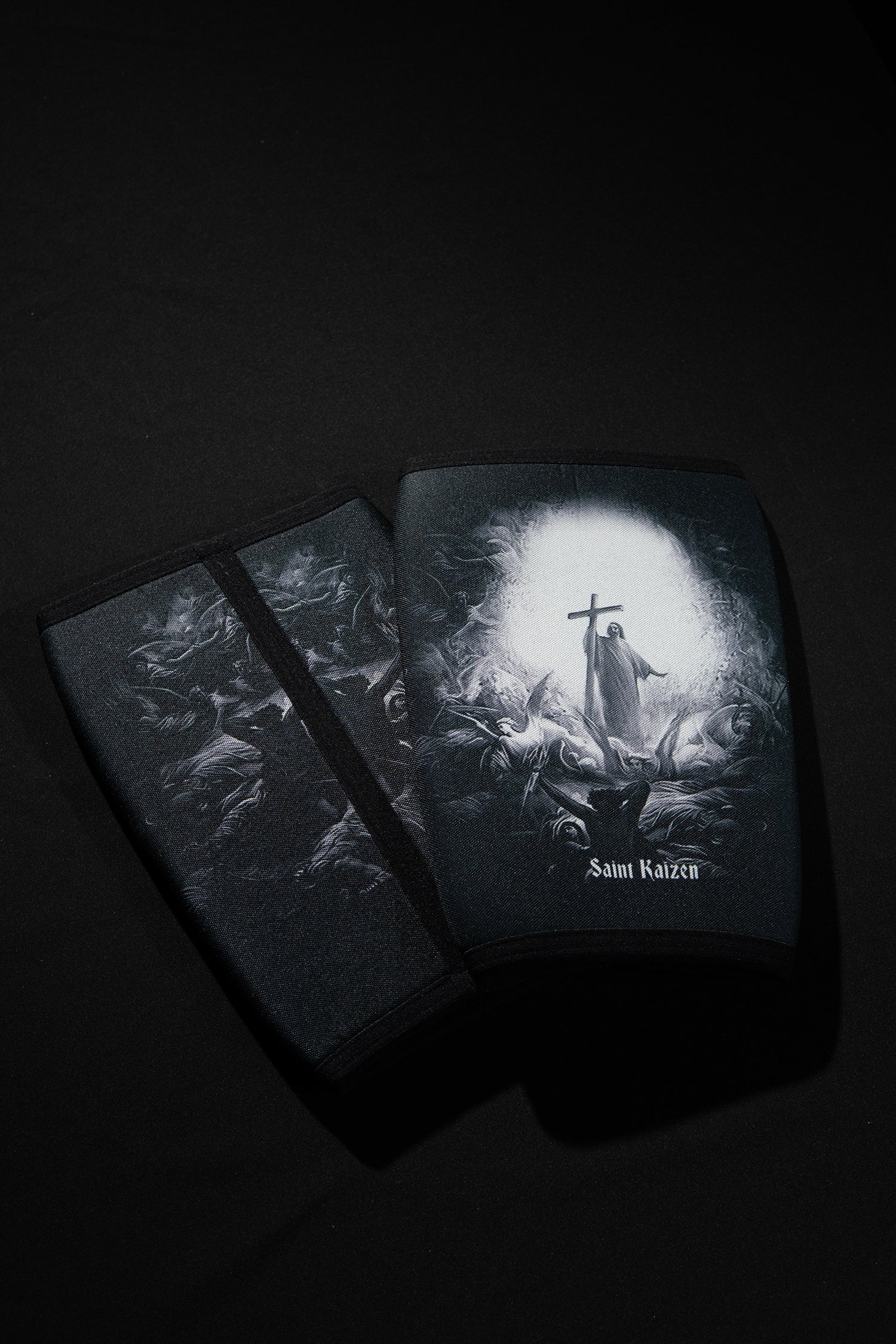Saint Kaizen Light In The Darkness Knee Sleeves. 7mm neoprene for maximum compression and support during squats and deadlifts. Essential Christian gym wear.