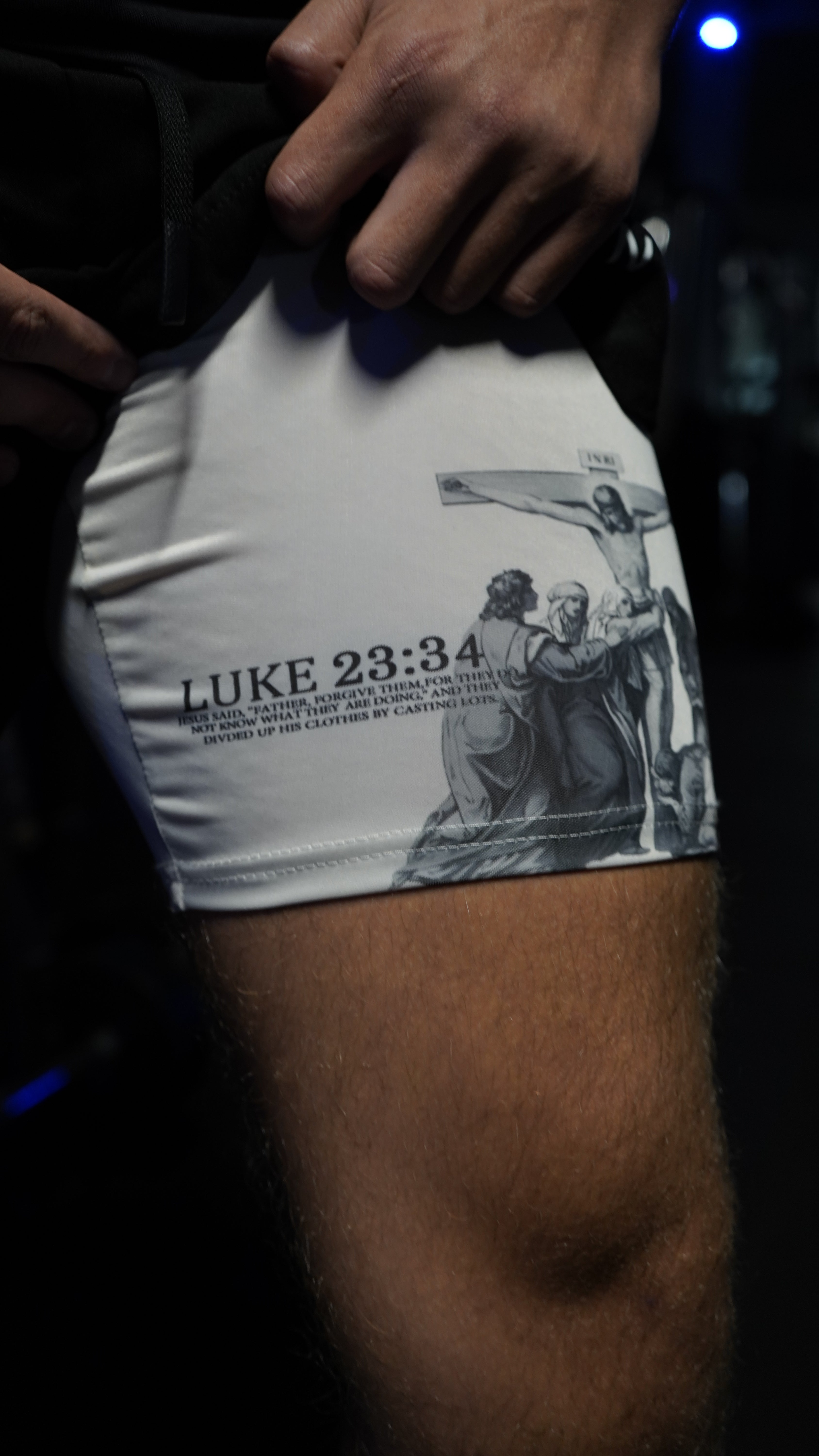 Saint Kaizen Christian gym wear Luke 23:34 Performance Shorts - Black. Two-layer shorts built for optimal mobility, featuring secure pockets and premium fabric.