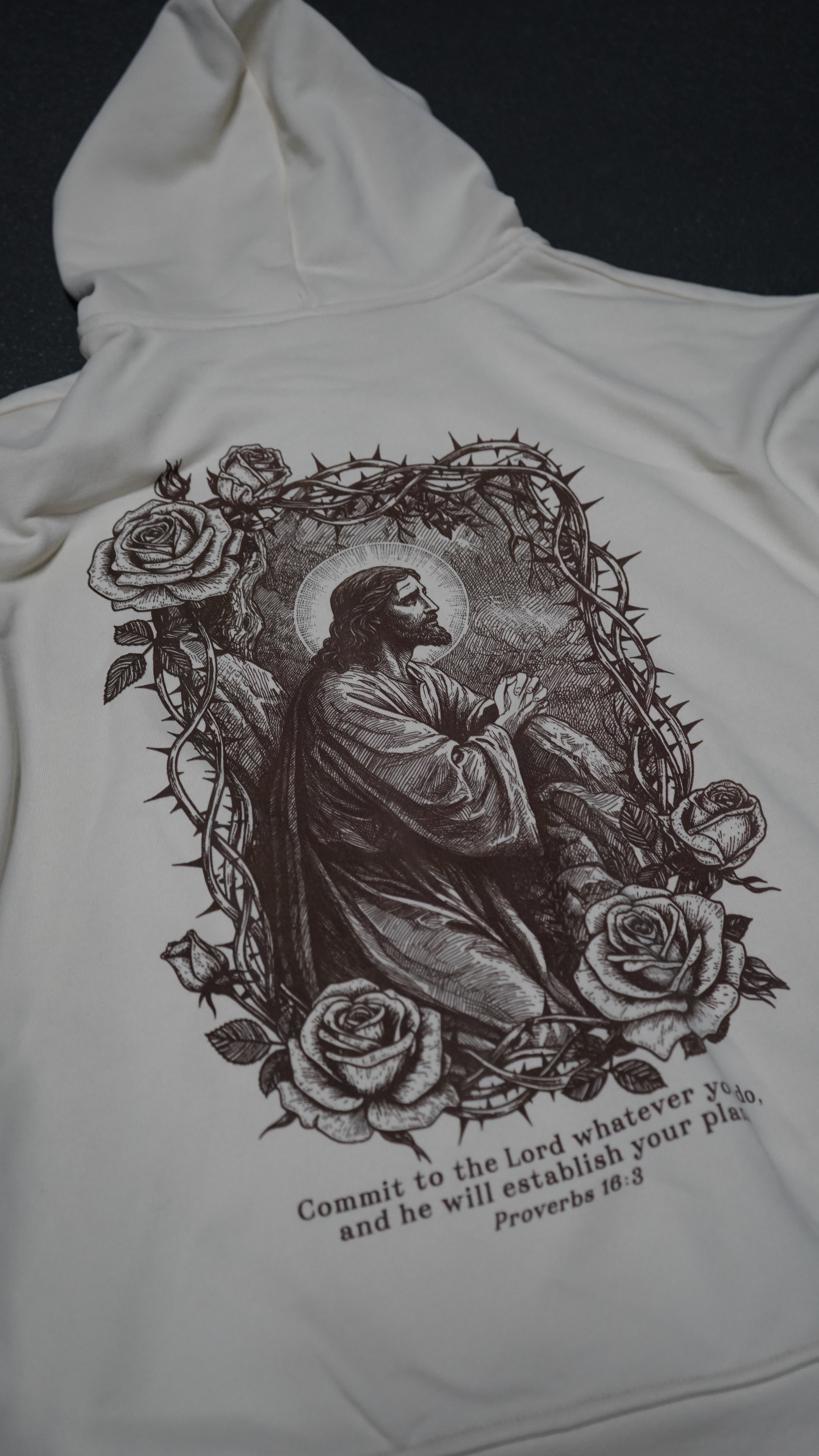 Saint Kaizen Proverbs 16:3 Hoodie - Cream. Heavyweight Christian gym wear hoodie featuring a durable with spiritual artwork.