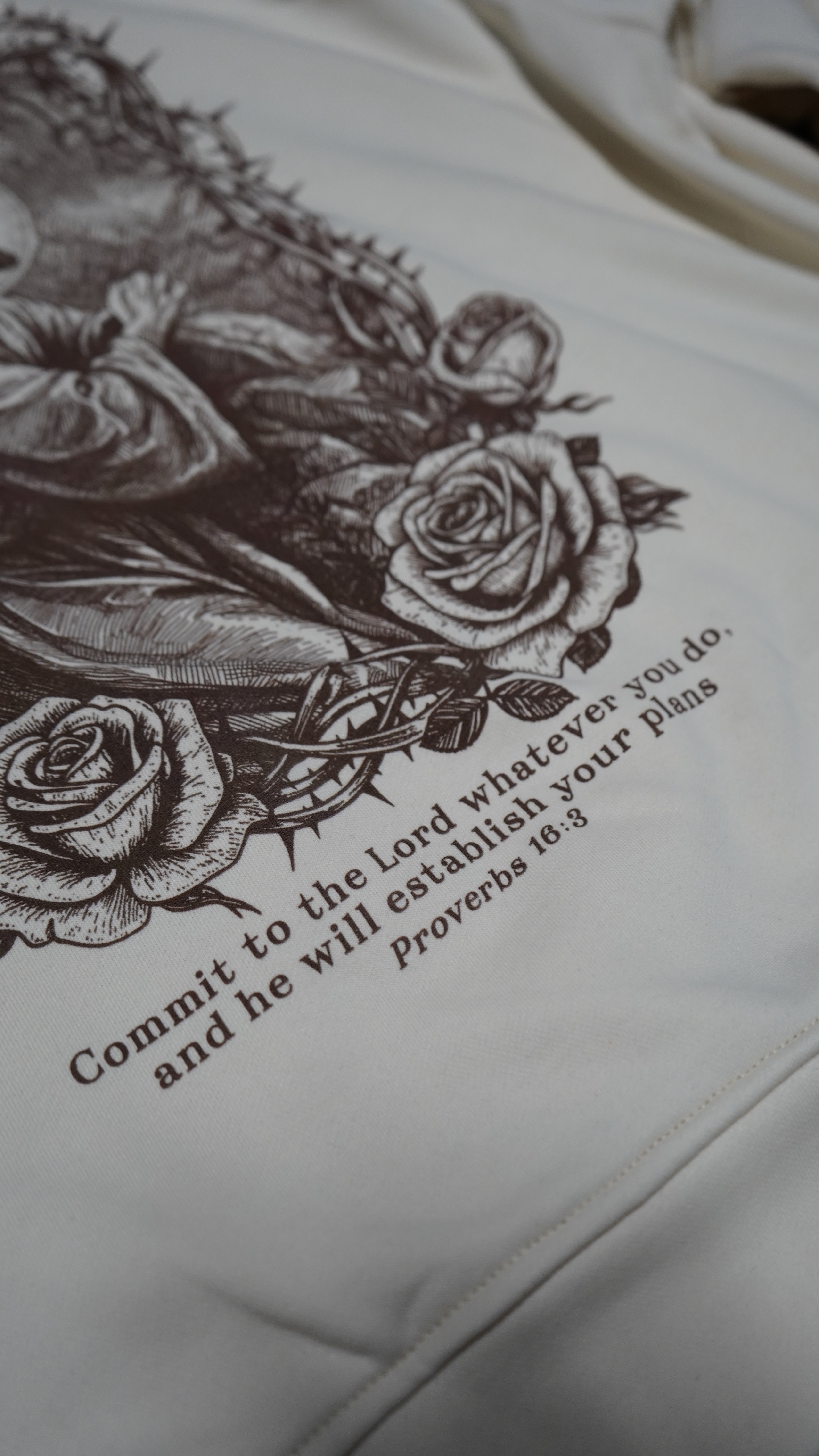 Saint Kaizen Proverbs 16:3 Hoodie - Cream. Heavyweight Christian gym wear hoodie featuring a durable with spiritual artwork.