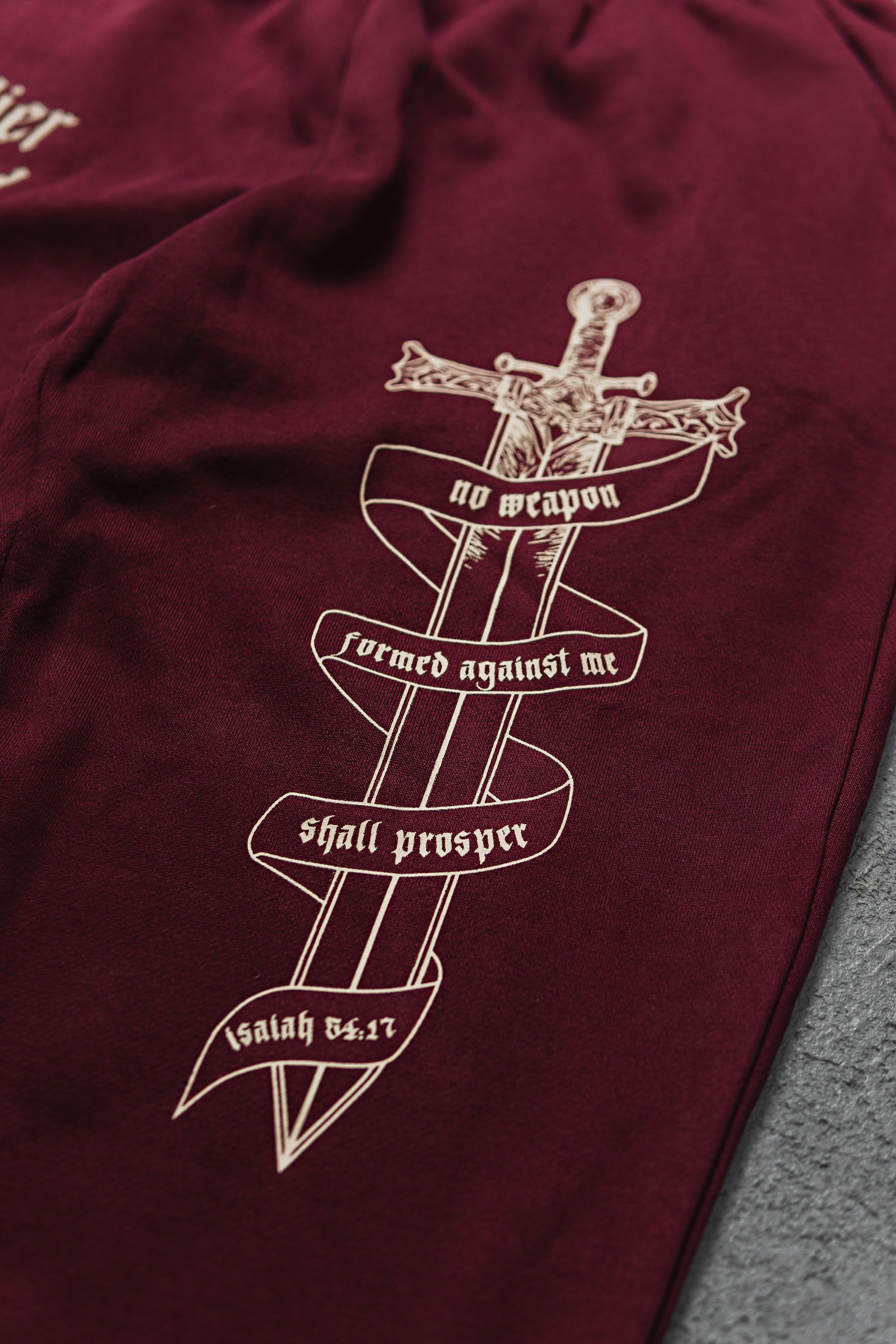 Saint Kaizen Soldier Of God Joggers - Wine. Christian gym wear with high-quality screen print design. Terry fleece lining for warmth and comfort.