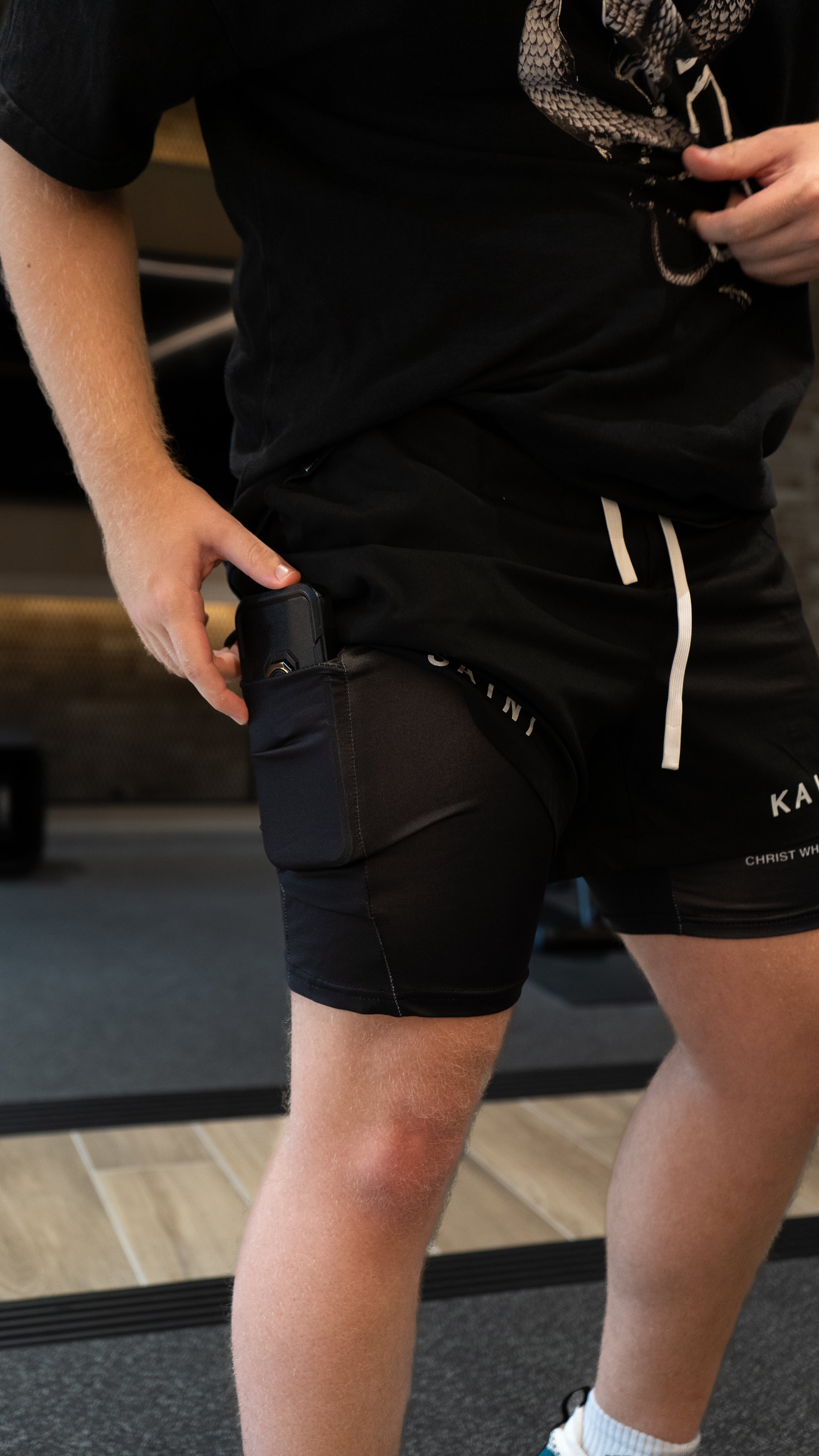 Christian-themed performance shorts with Bible verses, made from a blend of cotton and polyester with a spandex inner lining, featuring Saint Kaizen screen print and multiple pockets for convenience.