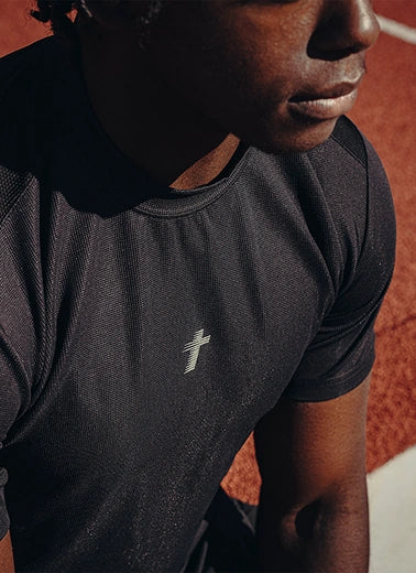 Black performance tee on the running track