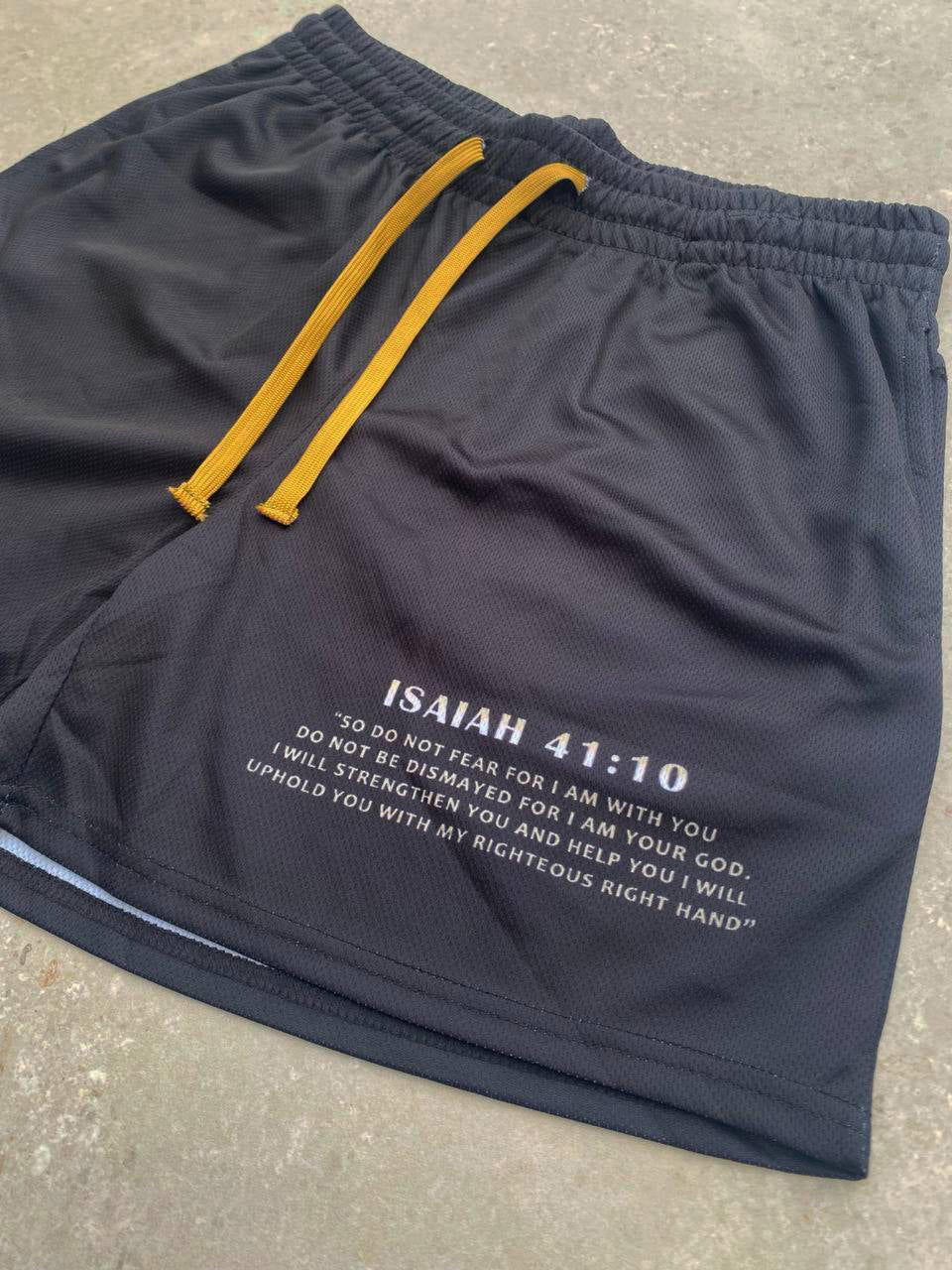 Christian-themed mesh gym shorts with Bible verses, made from 100% polyester, featuring double side pockets and a 5-inch inseam for comfort and mobility.