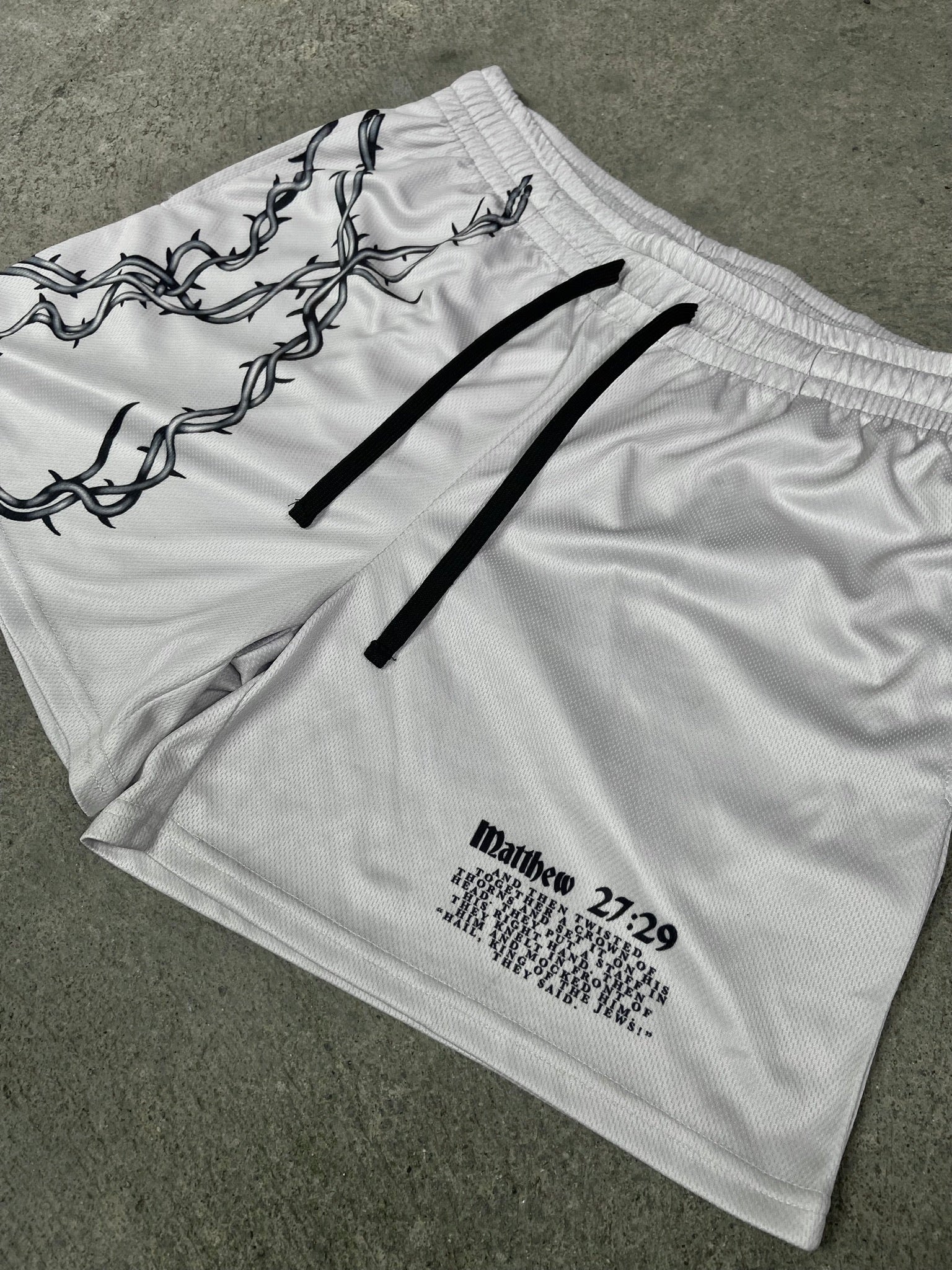 Christian-themed mesh gym shorts with Bible verses, made from 100% polyester, featuring double side pockets and a 5-inch inseam for comfort and mobility.